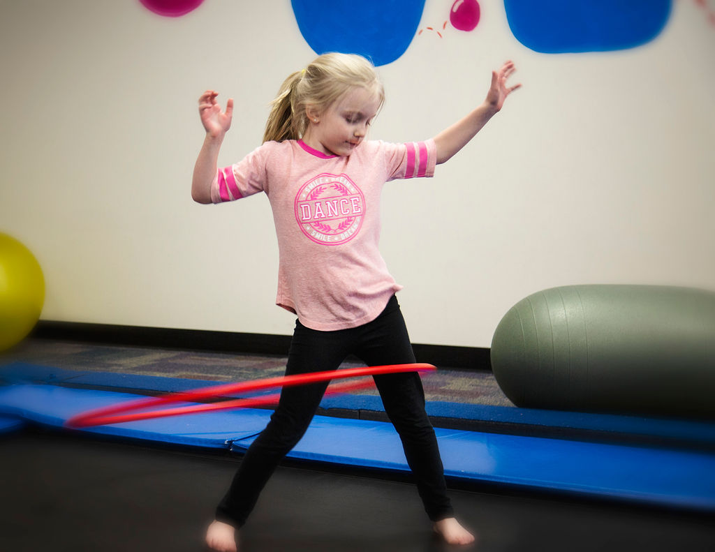 Girl with hula hoop on trampoline