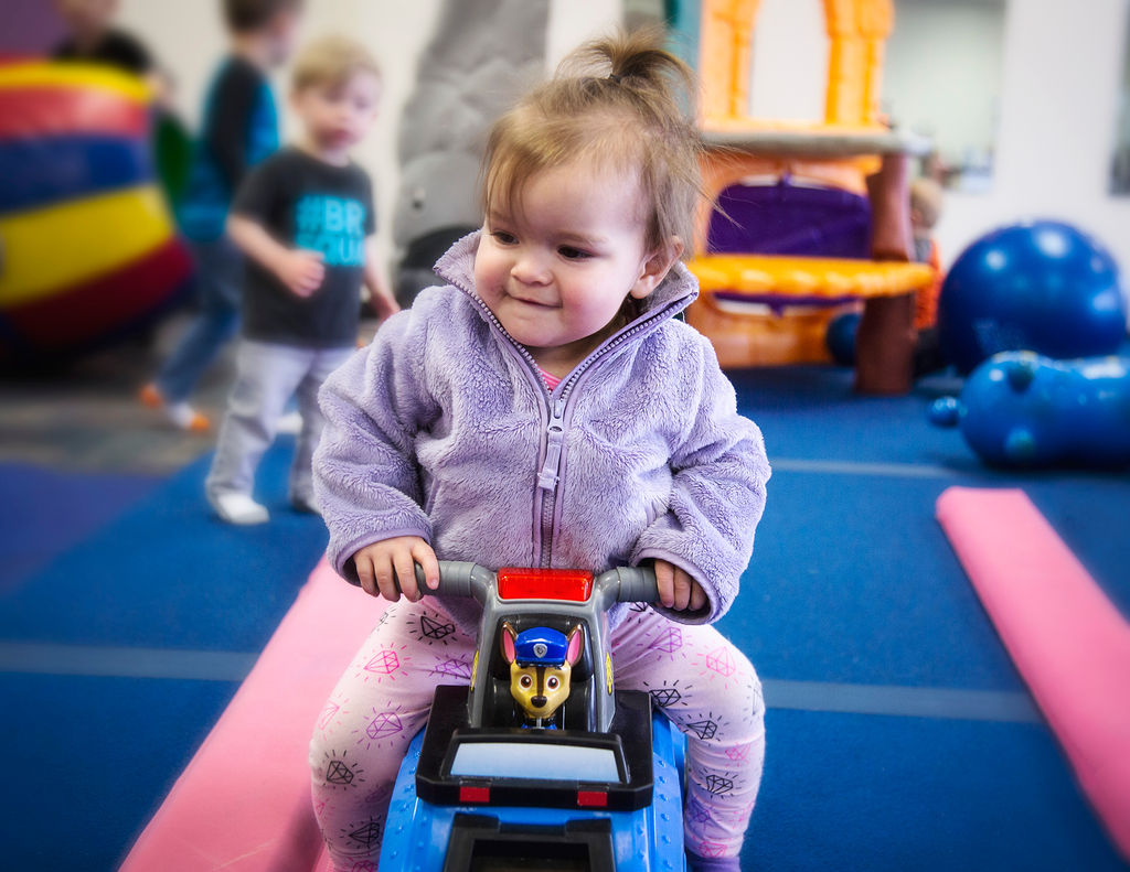 Girl on ride on toy