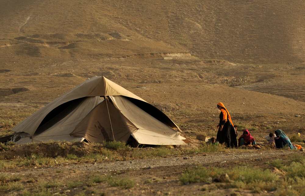 Afghan nomad women sit on the ground near their tent in Kabul on July 06, 2008. Estimates are that up to 80 percent of economic activity in Afghanistan is undertaken by informal players who do not have adequate incentives or mechanisms to formalize 