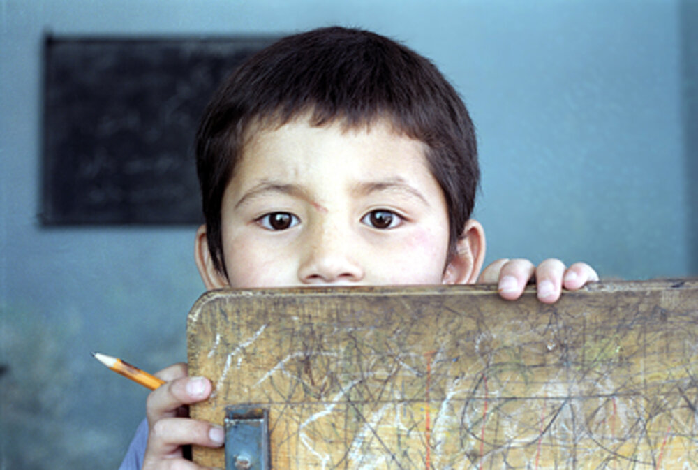  An orphan looks on as he participates in a class in Kabul Orphanage, Afghanistan, April, 17, 2003. Two decades of war in Afghanistan have left many thousands of orphans and abandoned children across the country.  AFP PHOTO/MASSOUD Hossaini   