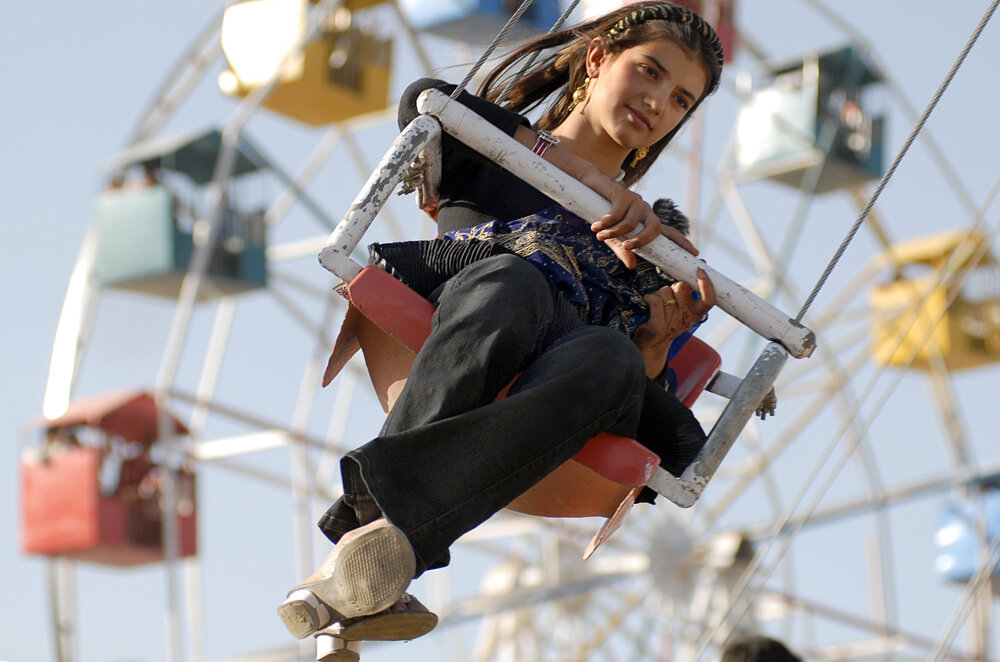  An Afghan girl rides at an amusement park on the last day of Eid al-Fitr, 14 October 2007 in Kabul. The muslim holiday marks the end of the holy month of Ramadan.    AFP PHOTO/MASSOUD Hossaini  