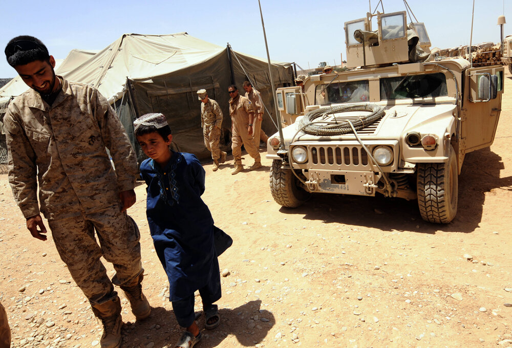  An Afghan boy Aziz, 10, walks with an afghan man as he injured by Taliban in his village Garmser at Camp Dwyer in south of Helmand Province on May 5, 2008. Us Marine soldiers push out Taliban from Garmser village several days ago.Helmand, the main s