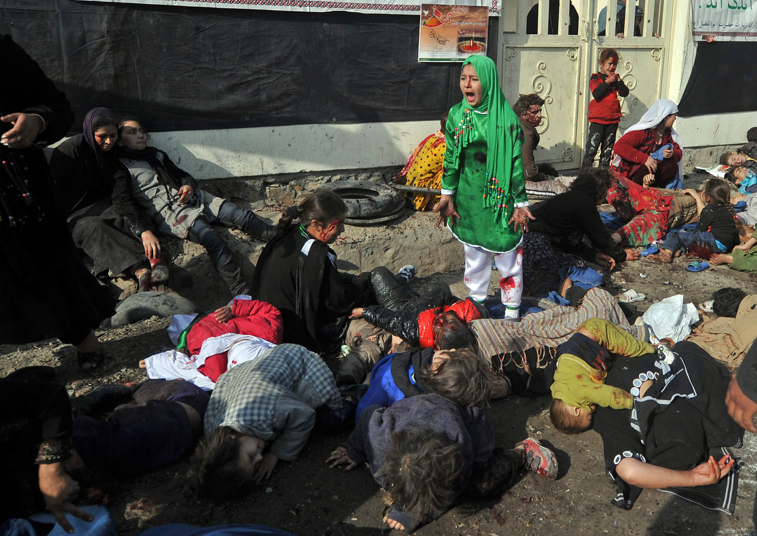  Tarana Akbari, 12, screams in fear moments after a suicide bomber detonated a bomb in a crowd at the Abul Fazel Shrine in Kabul on December 06, 2011.  Out of 17 women and children from her family who went to a riverside shrine in Kabul that day to m