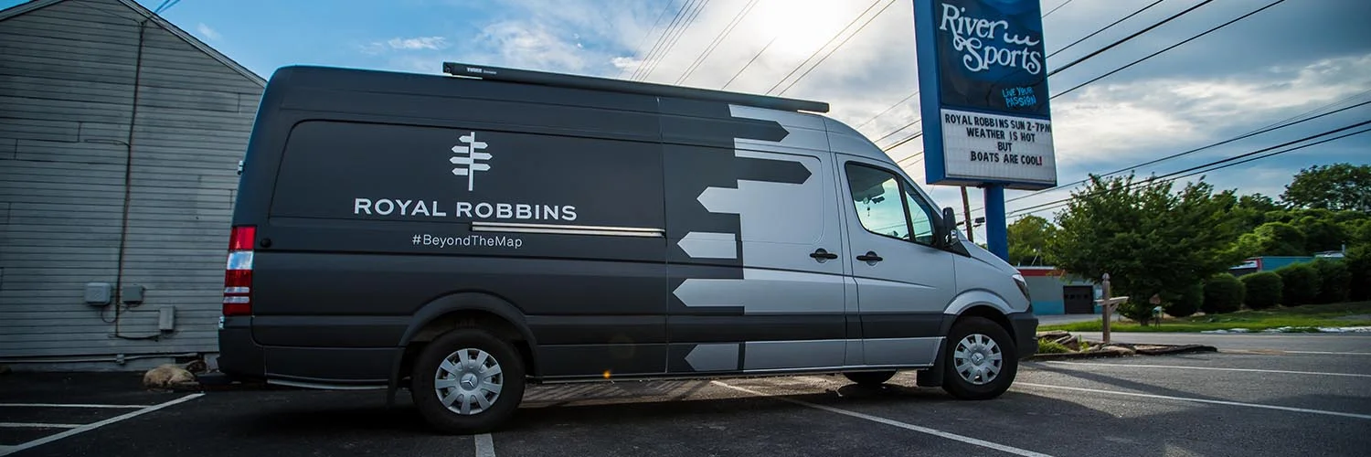 RR Van parked in front of River Sports Outfitters. Big signage for RR reminding all customers to stop by and check us out.