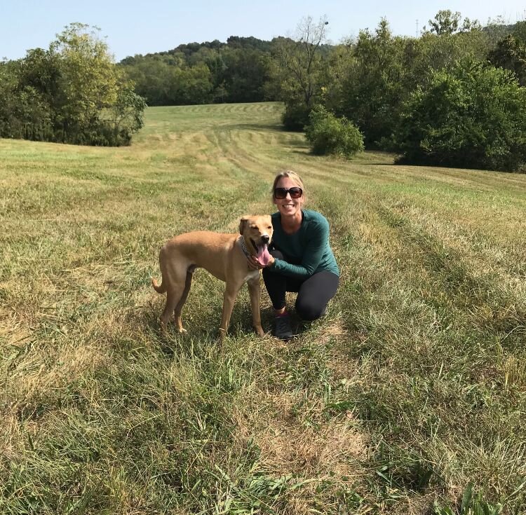 Julie Evans and her dog in a field.jpeg