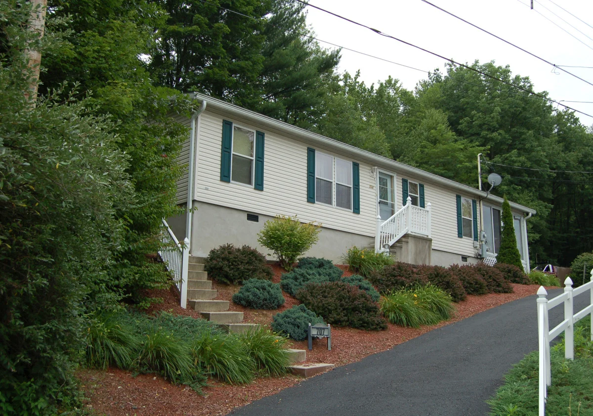 Manufactured Home on Concrete Crawlspace Concrete Front Steps with Vinyl Railing.