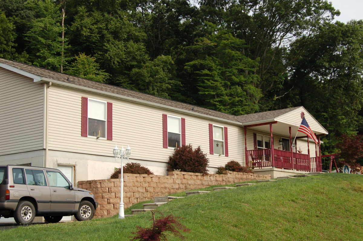 Manufactured Home On Concrete foundation, Covered Concrete front Porch.