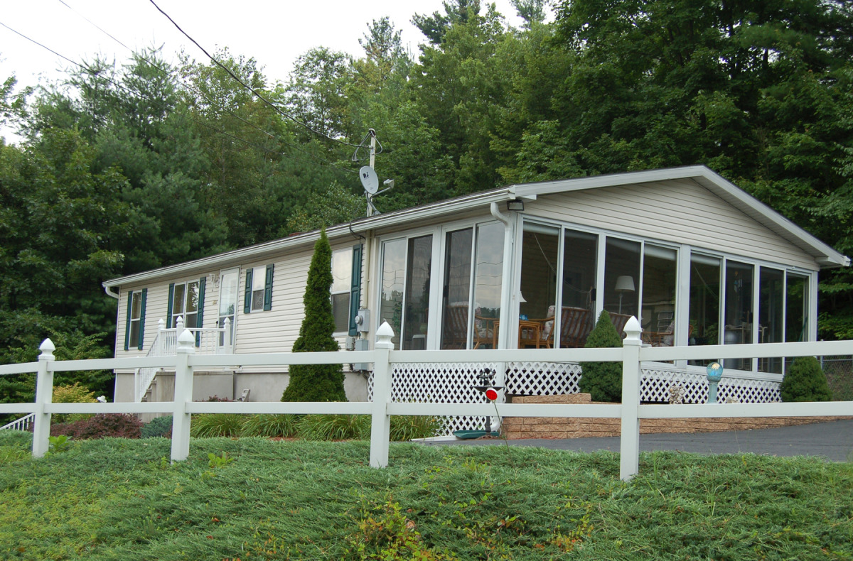 Manufactured Home On Concrete Crawlspace, Showing a Site Built Sunroom addition. View from Right Gable.