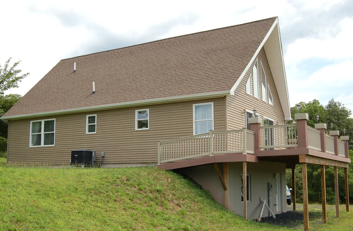 Exterior View Rear showing Composite Deck and Ramp to rear yard. Electric Heat Pump