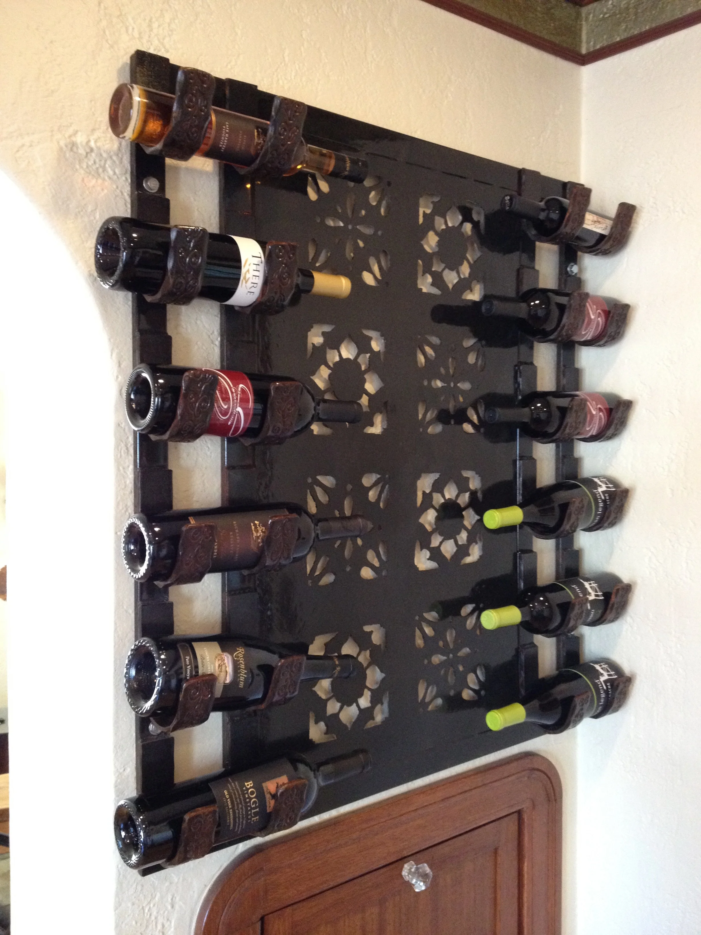 Spanish Style Wine Rack This wine bottle rack complements the classic aesthetic of the client's 1920s Spanish-style home. It features intricate hand-cut designs inspired by Spanish tile.