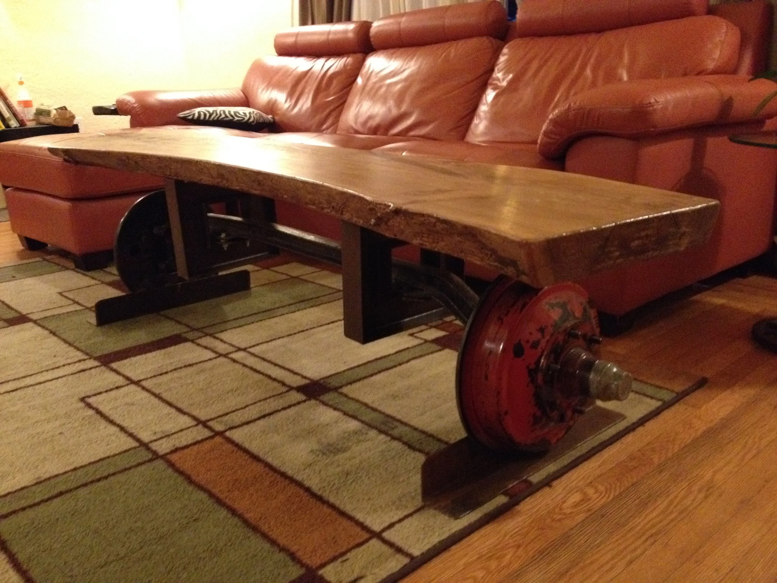 Axl - The Bench One of our first furniture pieces, this bench features a 1940s Chevy truck axle, atop which is mounted a sturdy slab of live-edge Elm wood.