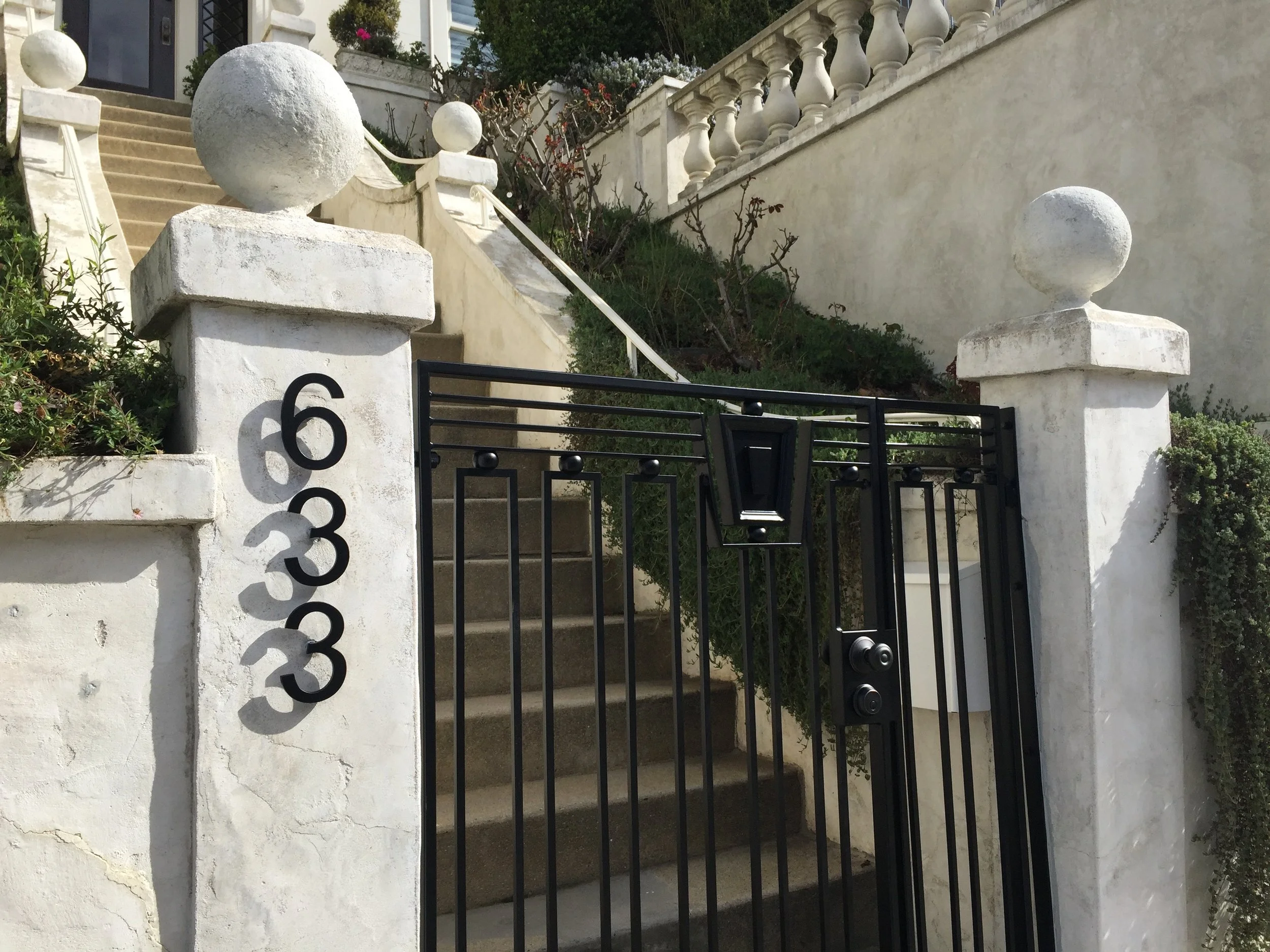 Edwardian style gate Custom entry gate with accents to match the home’s distinctive wood moldings.