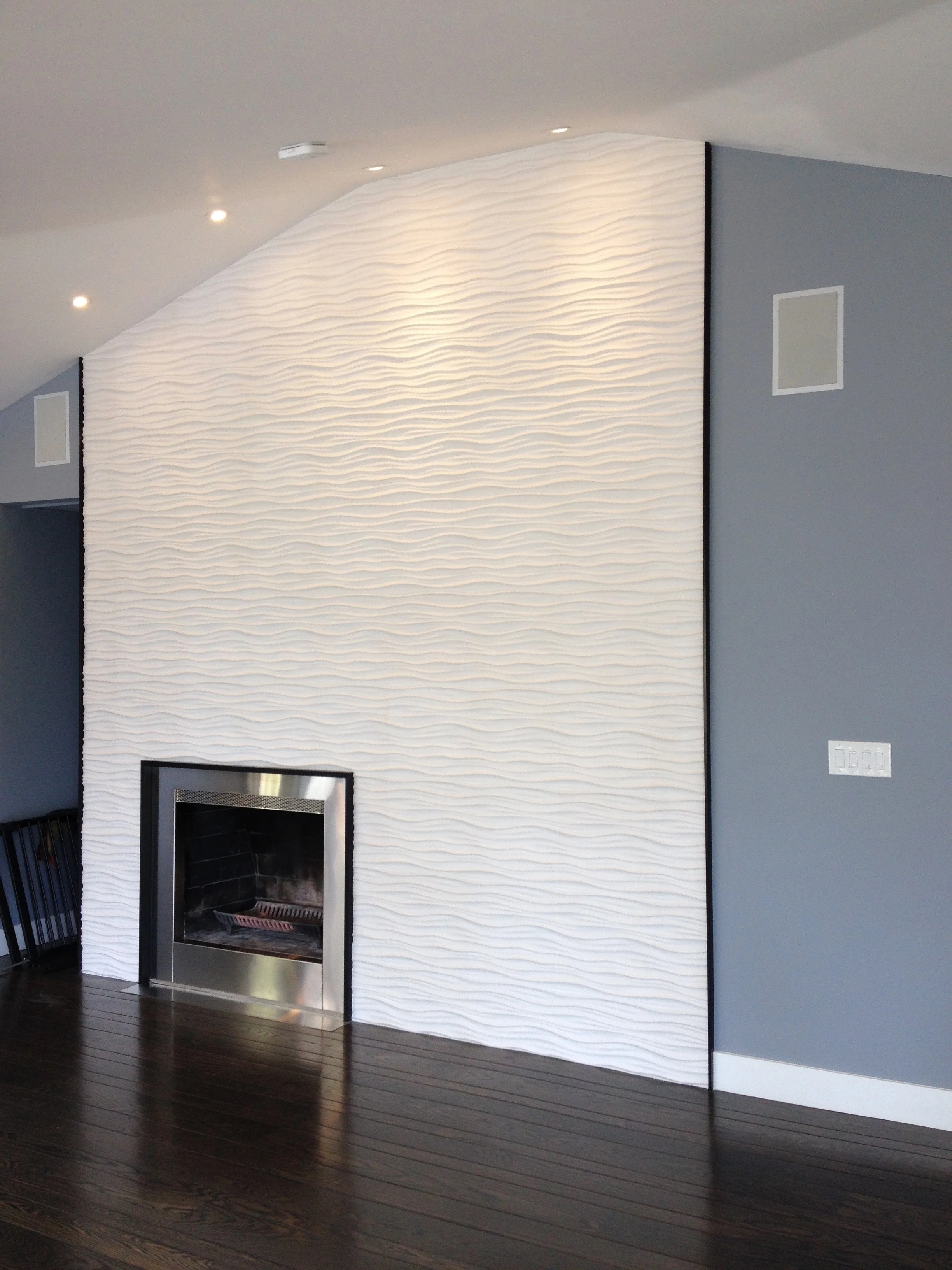 Stainless Steel Fireplace Surround This fireplace surround was a client's own design. Made from brushed stainless steel, it has a powdercoated tubular steel frame, and stainless steel hearth. The finishing touch is the custom-perforated stainless detail strip. Fire light will shine through the holes!