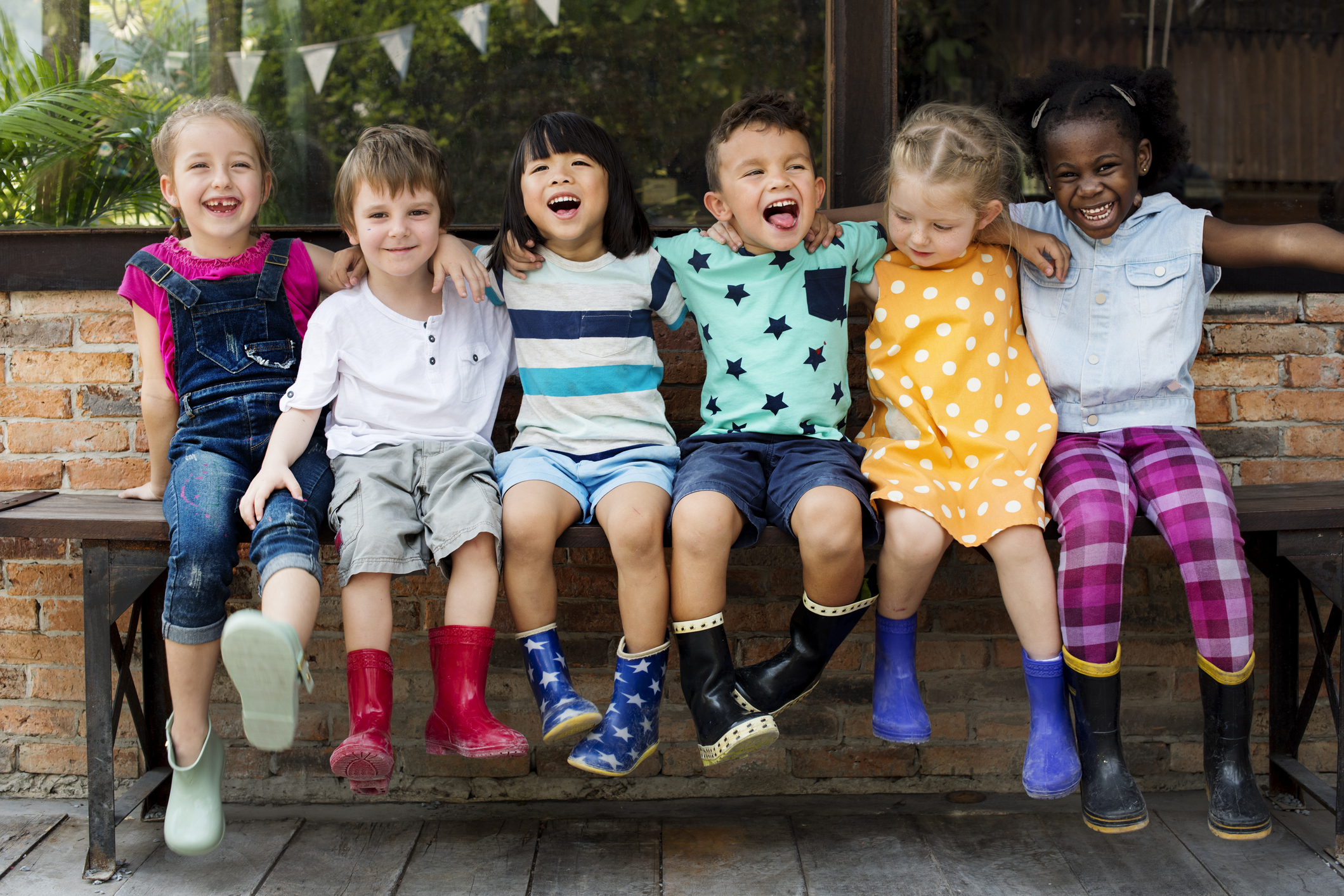Young Kids Smiling with Arms Around Each Other