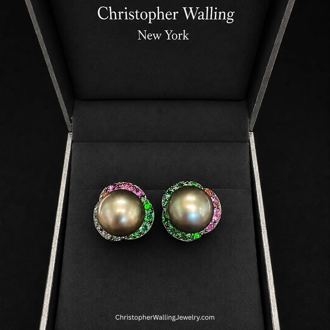Do two extraordinary 14 mm Natural-Color Black Tahitian Pearls deserve to be the centers of two colorful earrings?

I think so!

(Even if the petals are partly hidden from certain angles due to the curvature of the Pearls!)

2 cts. of Rubies, 2 cts. 