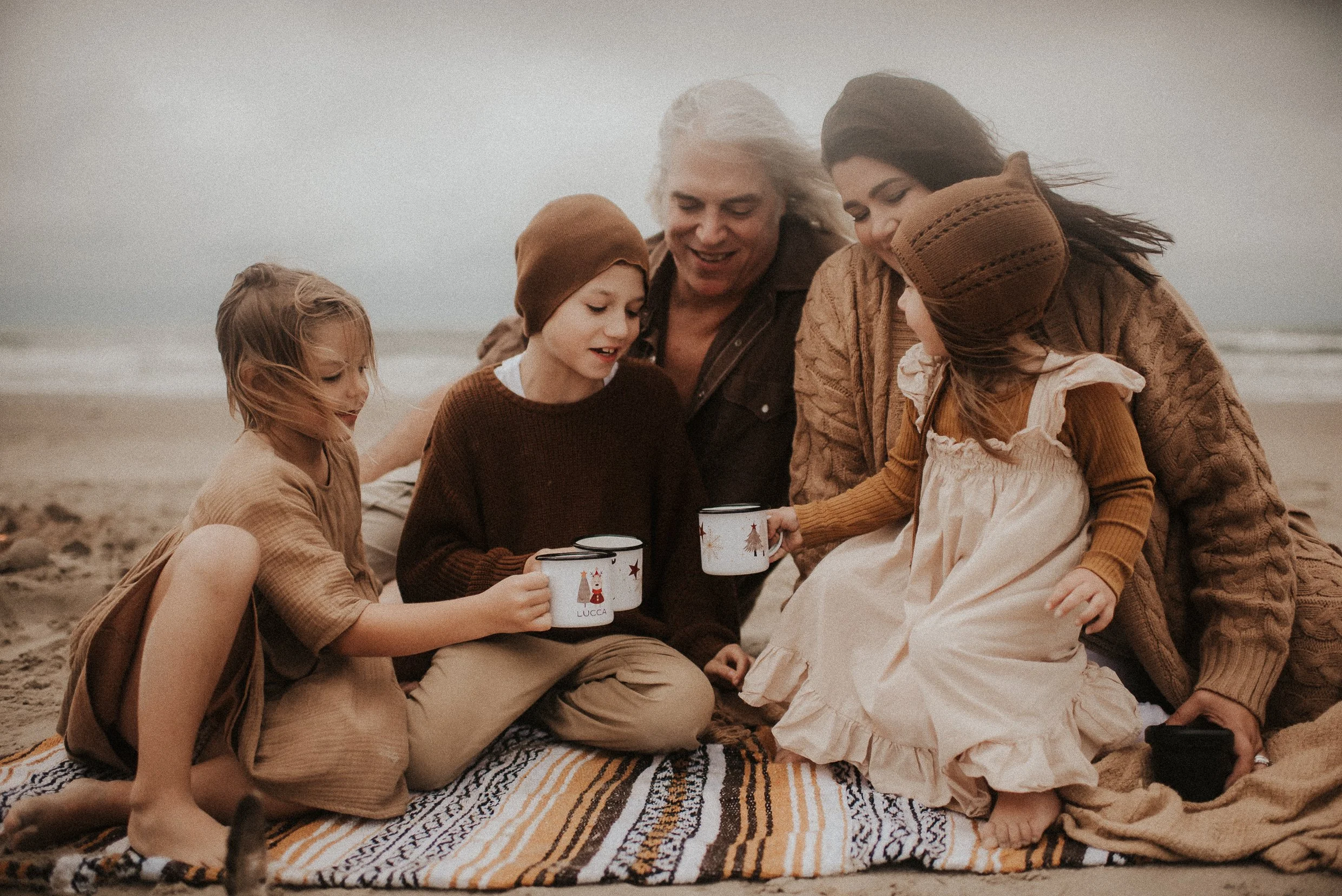 Moody playful campfire family session on the beach