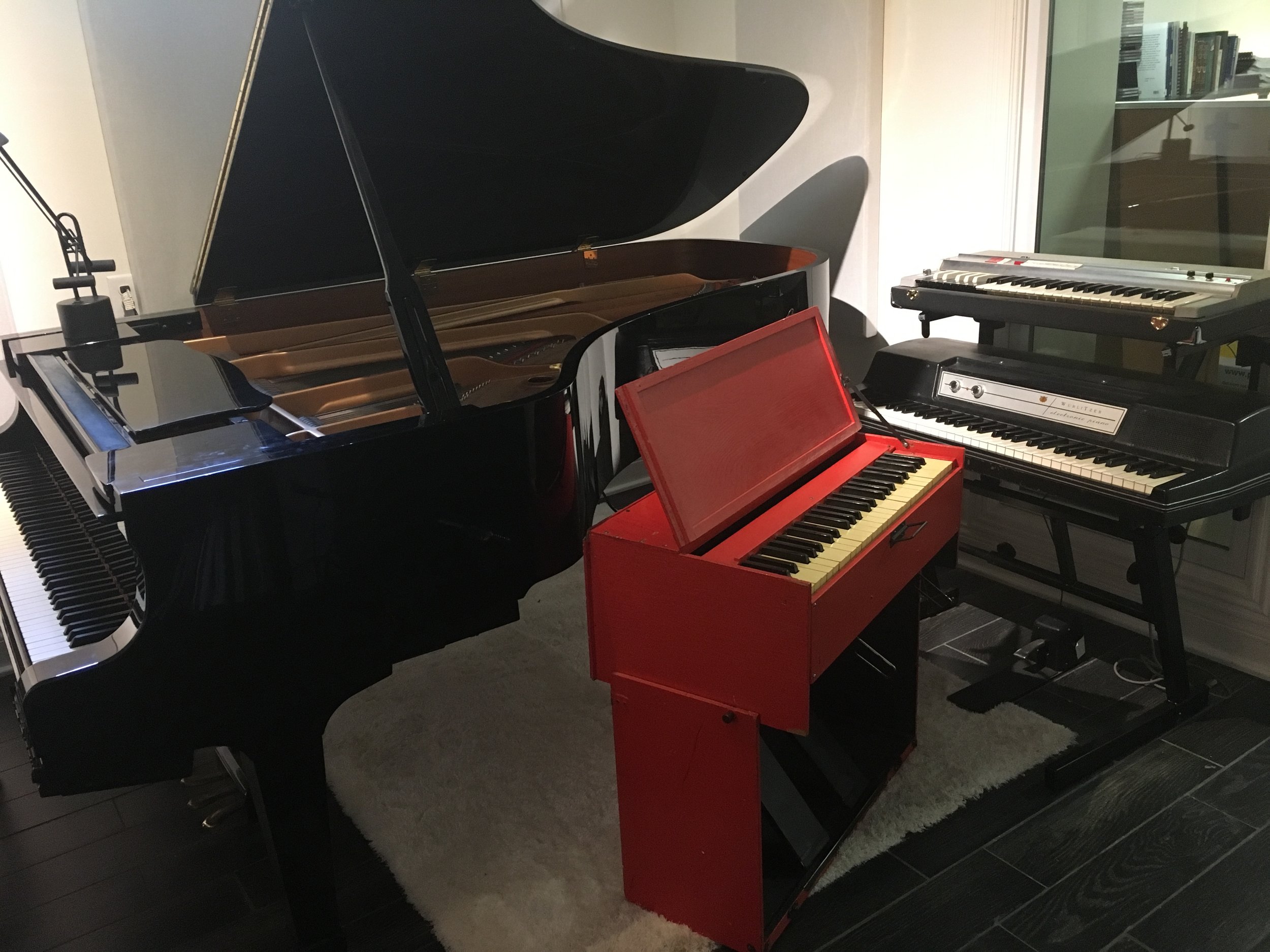 “Non-MIDI” keyboard booth view 2 (with WWII era chaplain’s pump organ, and the Teisco combo organ above the Wurlitzer...Japanese version of a Farfisa)