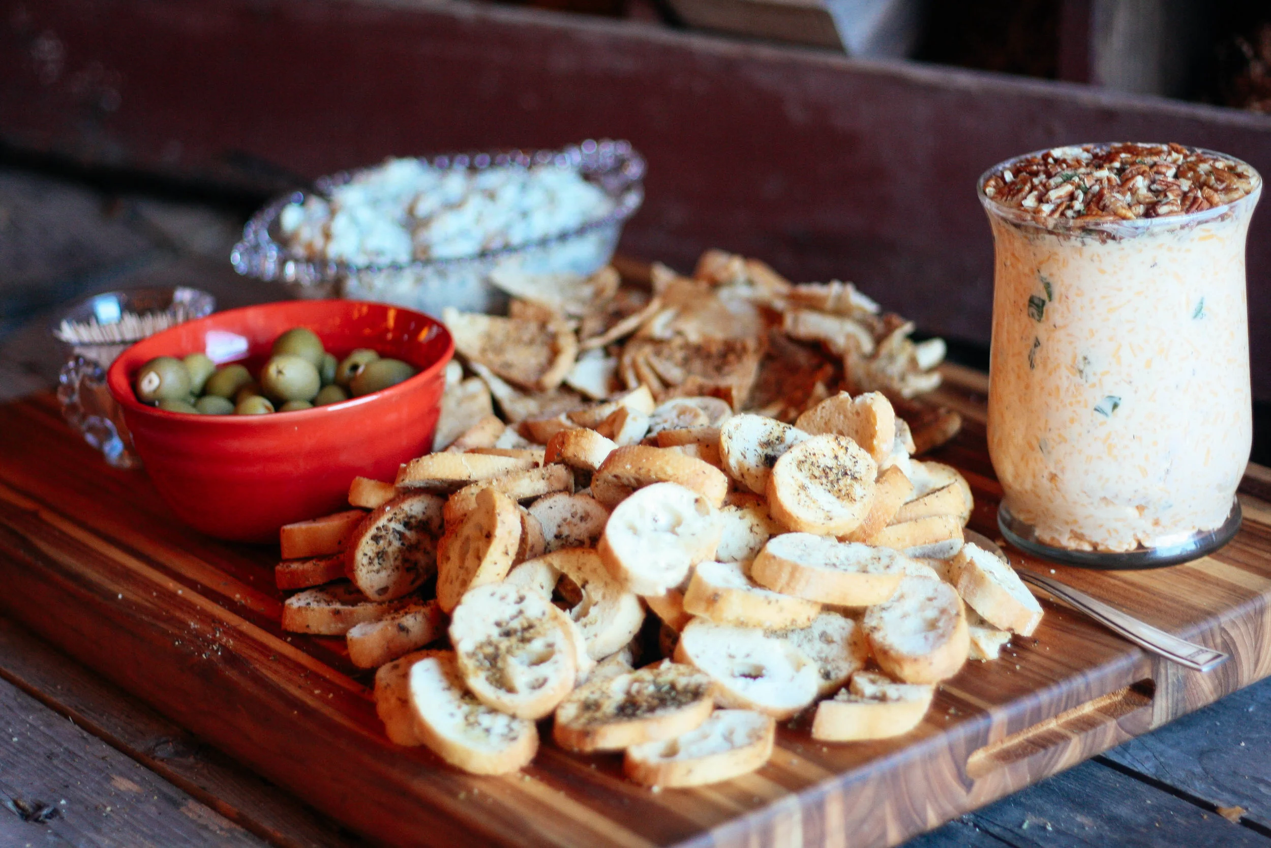 Homemade pimento cheese dip with local pecans, specialty olives and our “secret seasoned” bread bites!