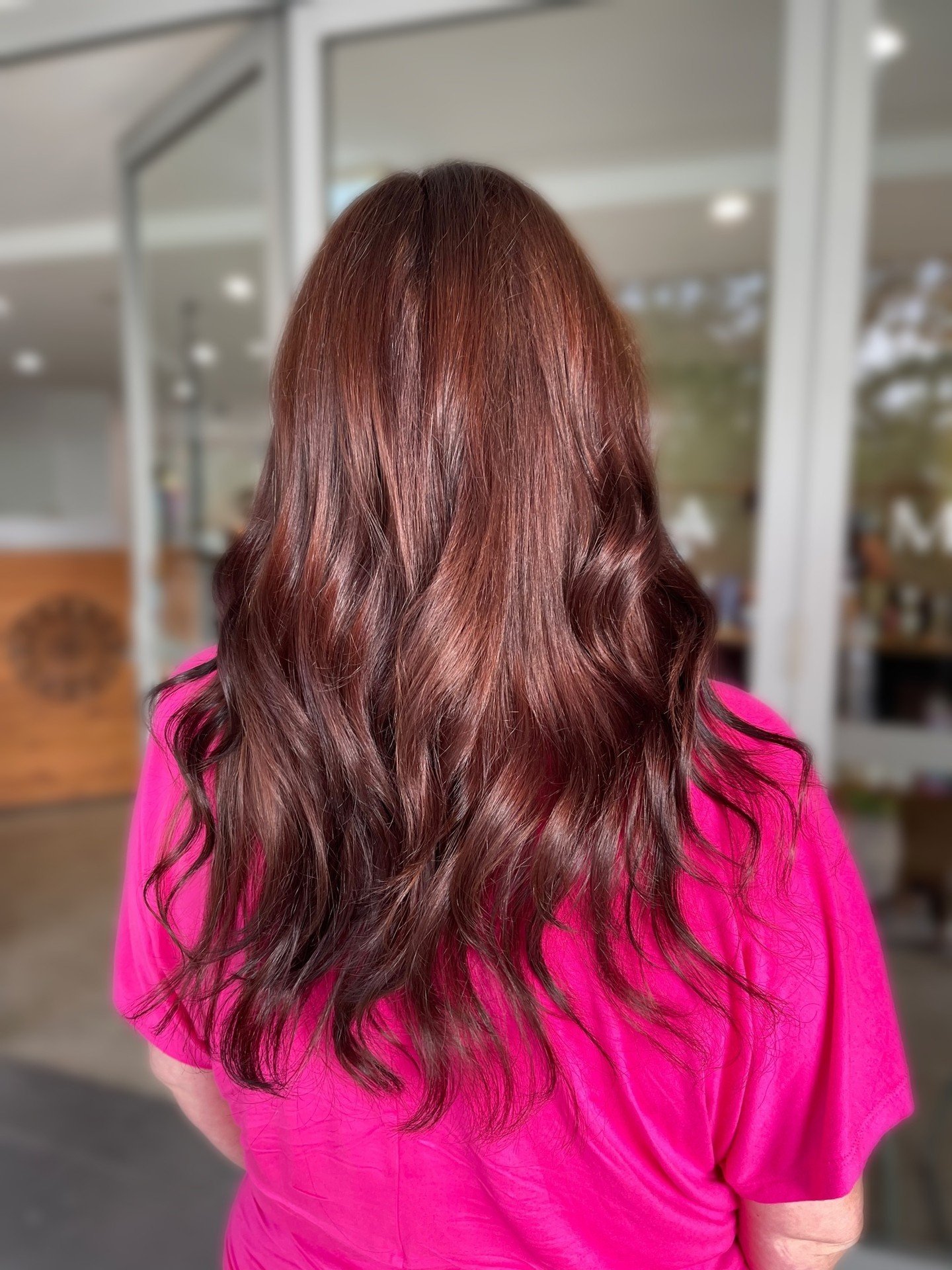 We recently had a client come to us with years of black hair dye, wanting to switch things up and go for a lighter, warmer brown. Naturally, we were thrilled to take on the challenge of a colour correction!

To achieve the desired shade, we first nee