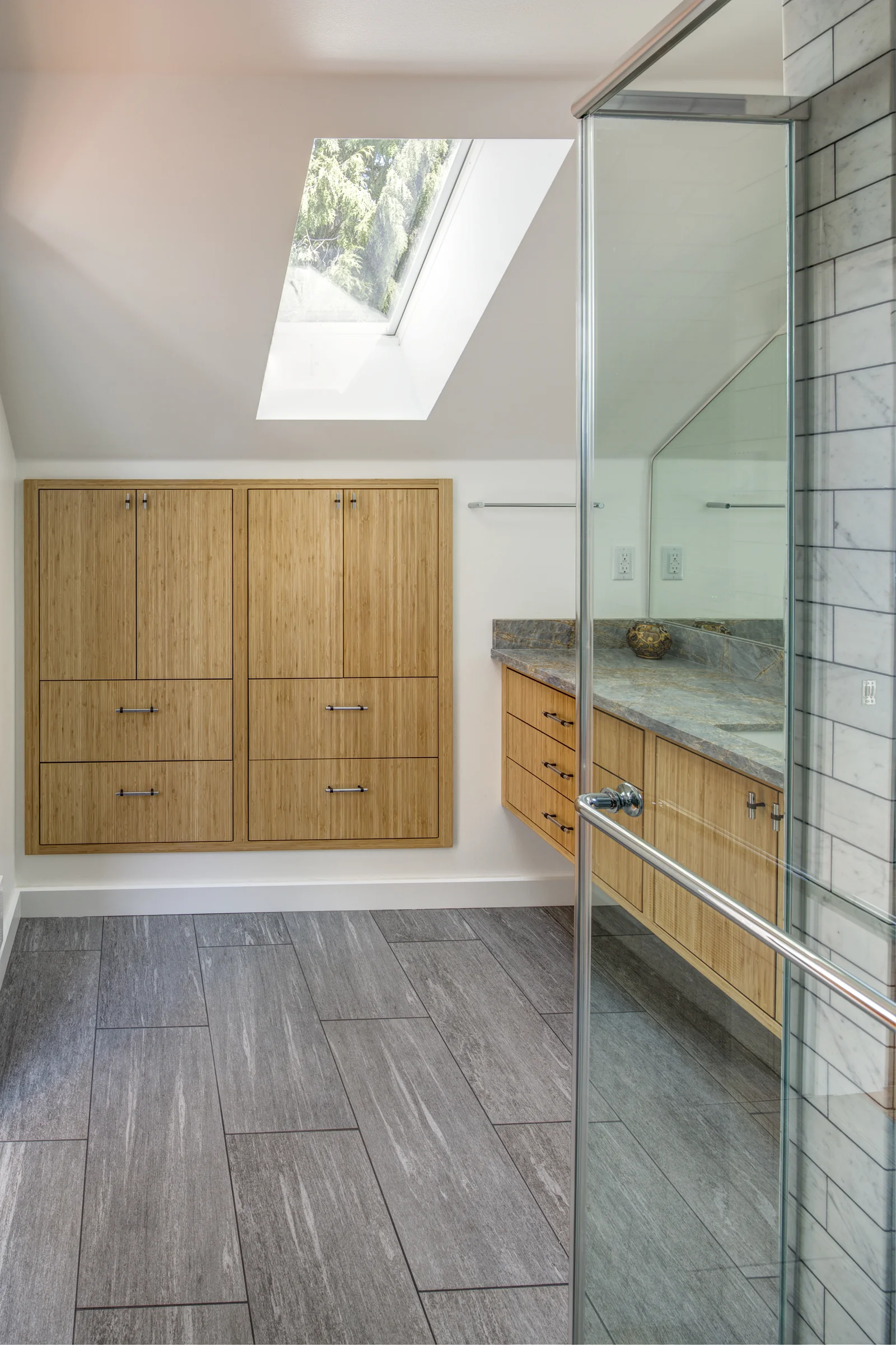 Bathroom Features Built-In Storage and Skylight