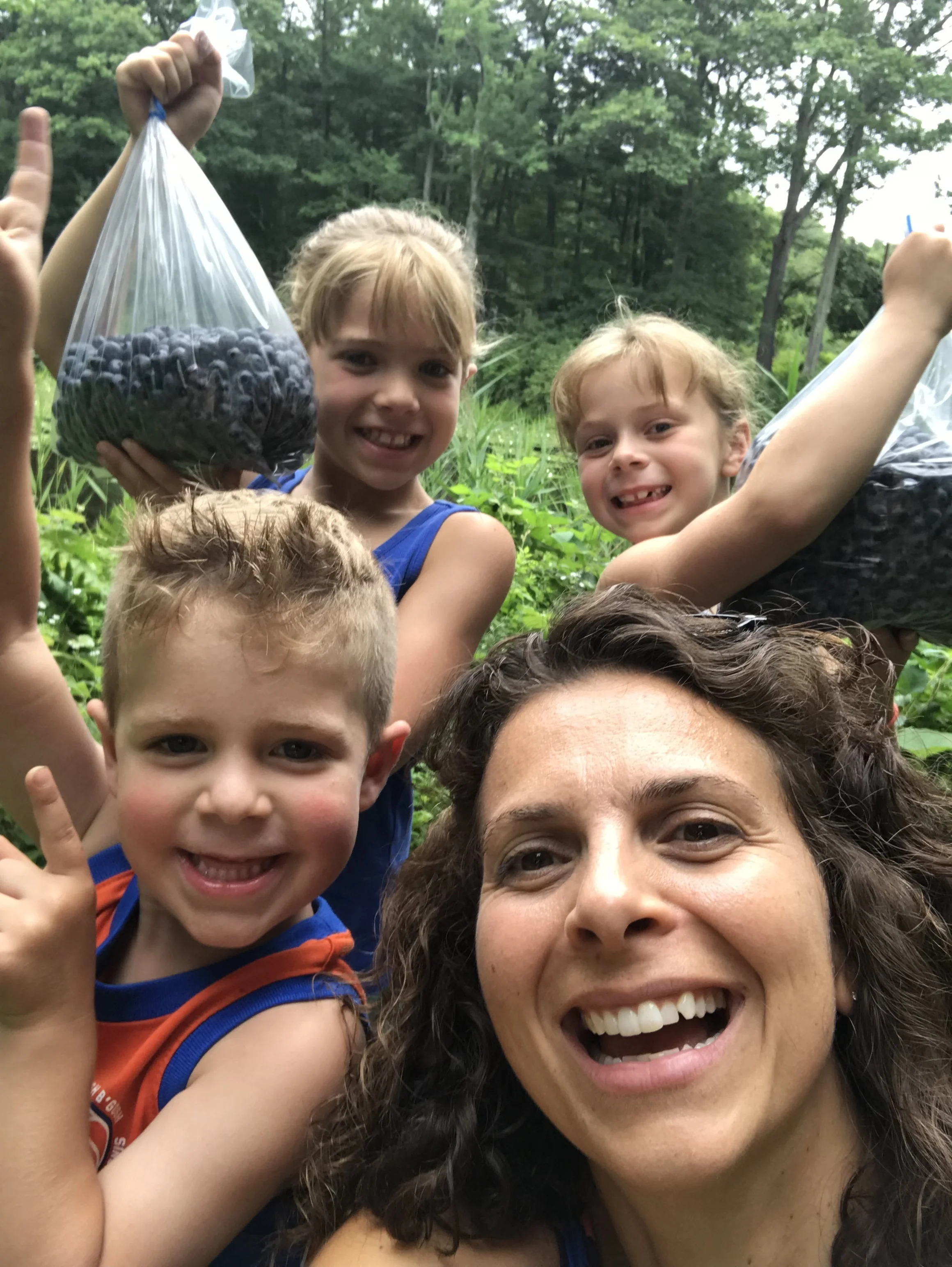 marisa and the kids out blueberry picking