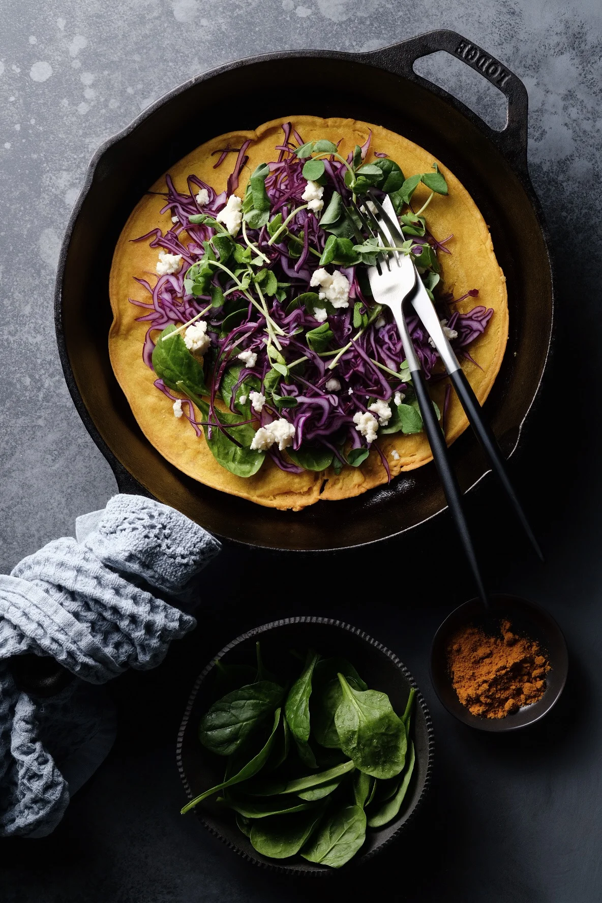 Turmeric socca with greens and red cabbage