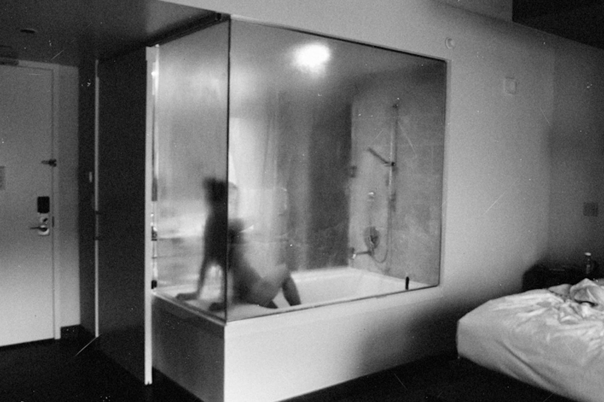 Woman is see through shower by Mel D. Cole