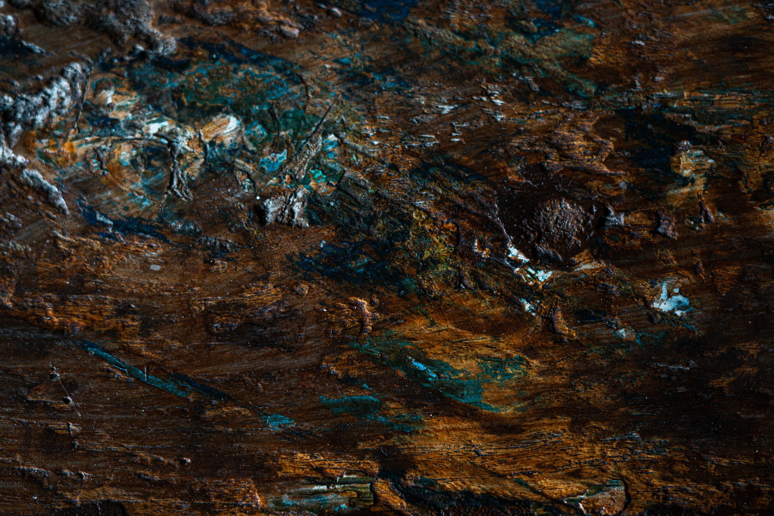 Macro photo of a mineral rock with browns, tans, blues and white.
