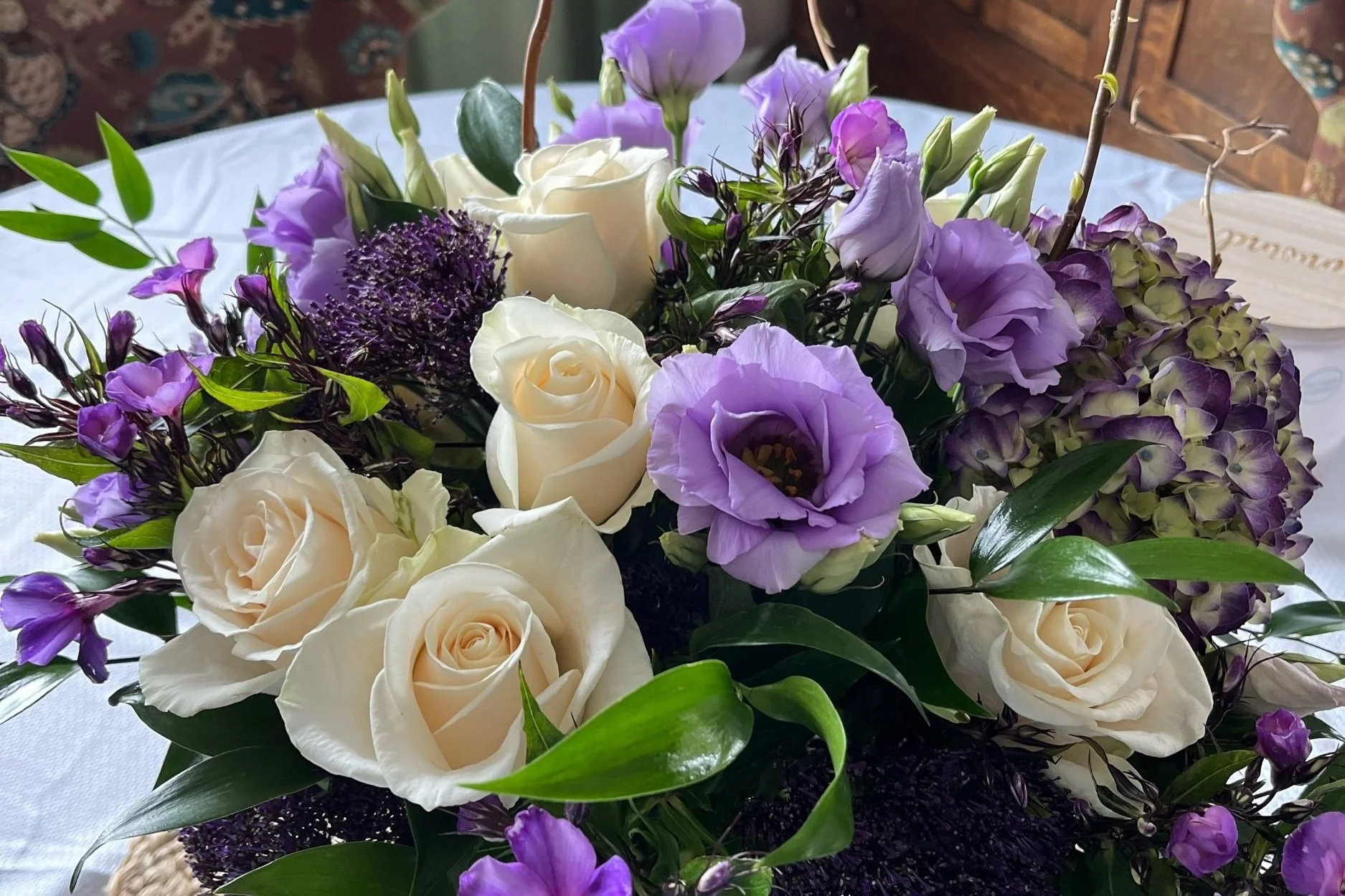 Elegant white and purple floral arrangement with lisianthus and imported hydrangeas by Snowdrops & Sage