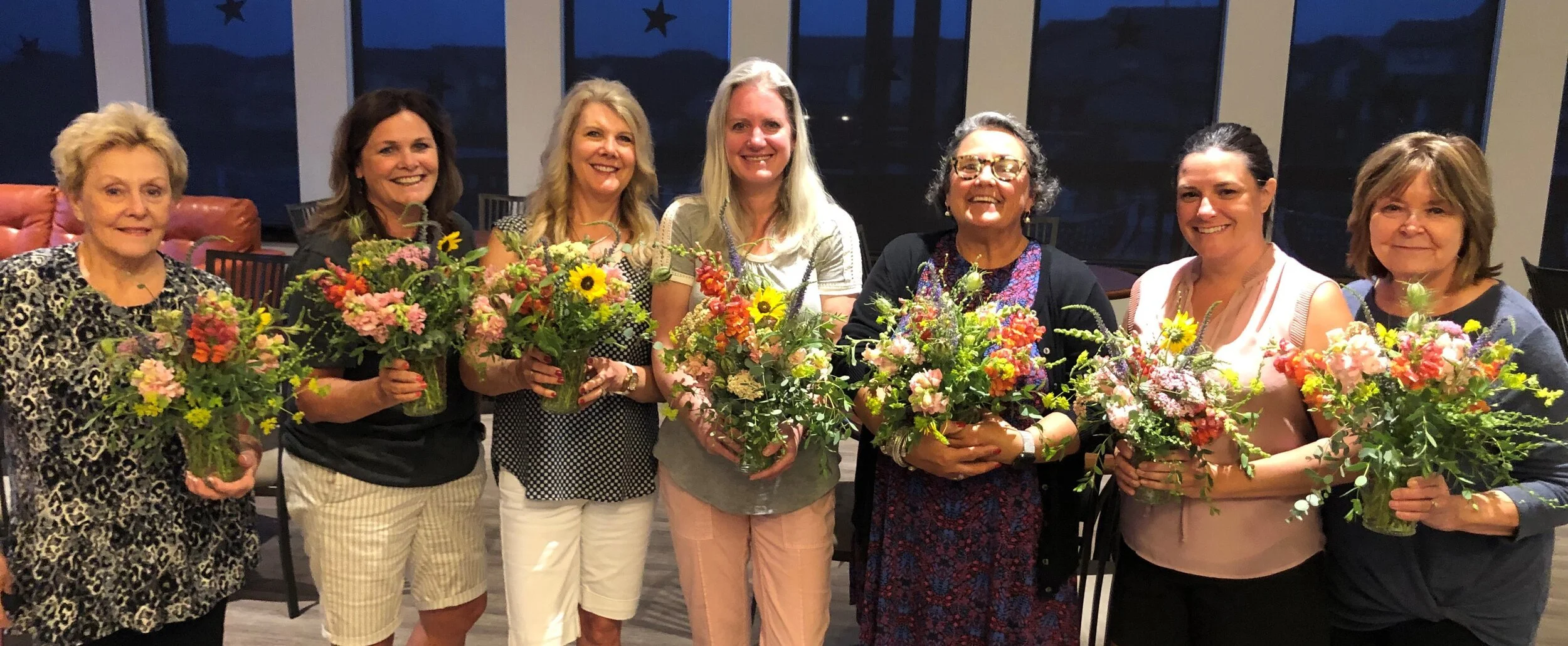 Group with flower arrangements in a workshop at Snowdrops & Sage in Arvada, CO
