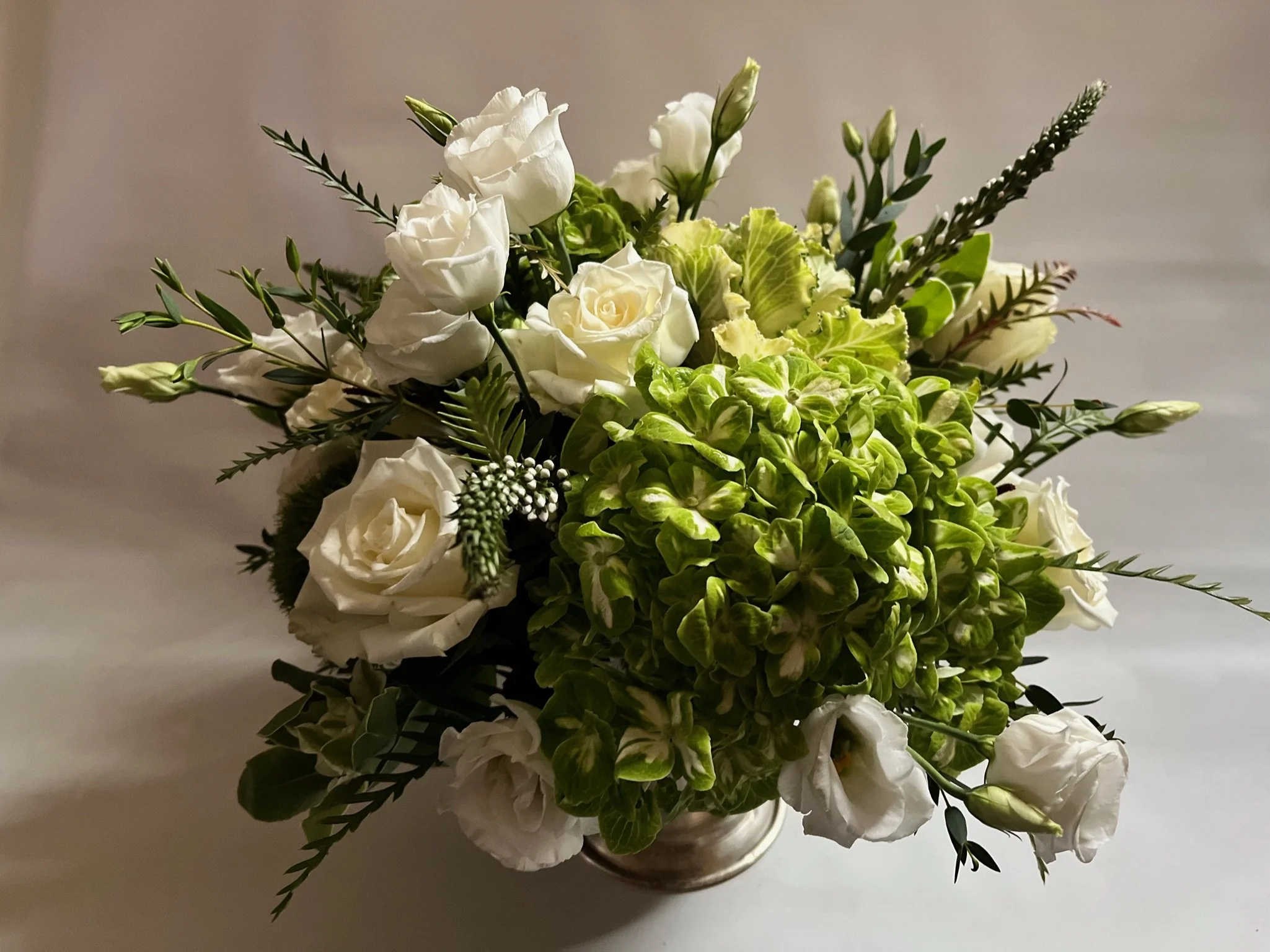 Classic white floral arrangement with creamy white roses and delicate lisianthus by Snowdrops & Sage