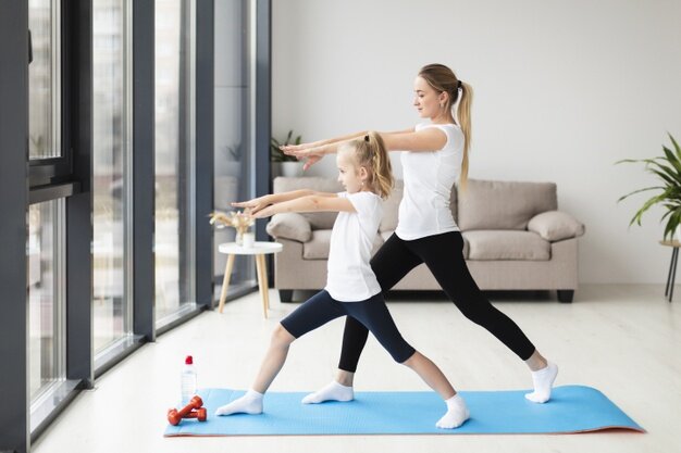 side-view-mother-exercising-along-with-child-home_23-2148492534.jpg