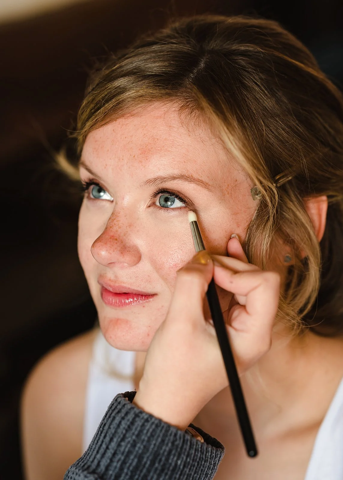bride having make up applied