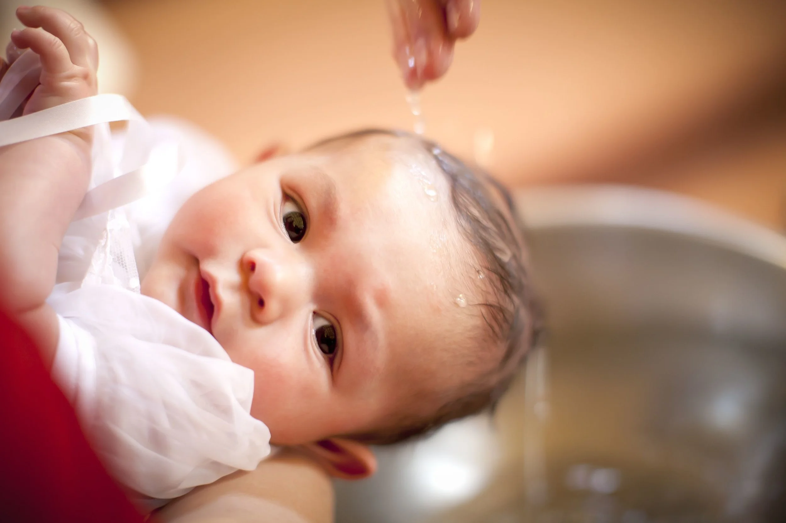 Babybaptism-GettyImages-155134002-5a3f489bbeba330037c9a01d.jpg