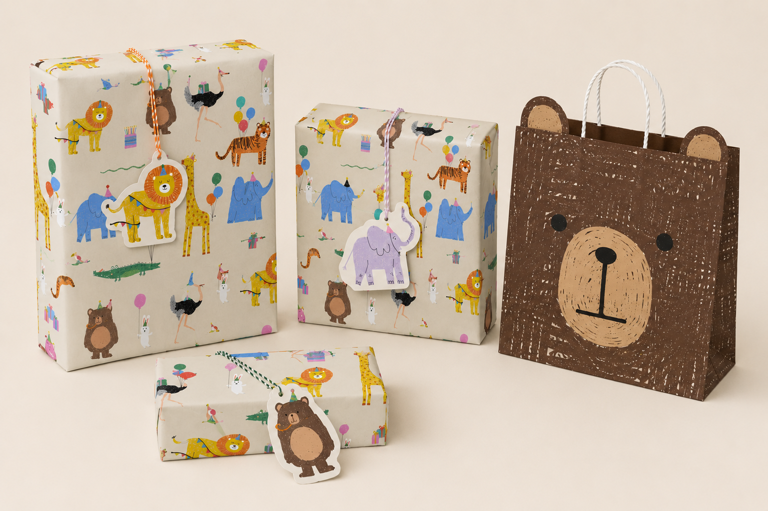 Three wrapped gift boxes with animal print wrapping and tags, and a brown paper shopping bag with a bear face illustration, on a beige background.