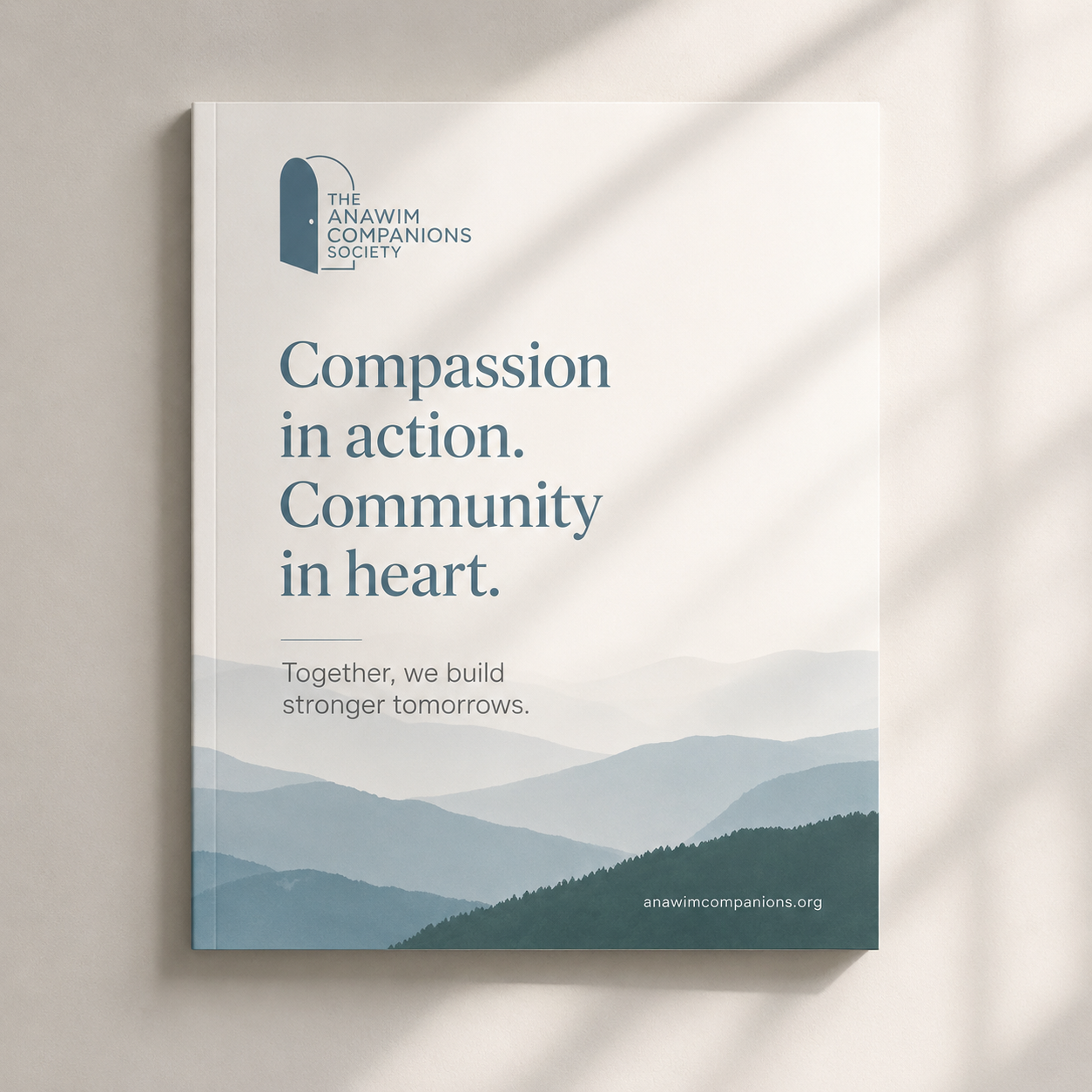 A brochure from The Anawim Companions Society featuring mountain landscape artwork with text about compassion and community, and the website anawimcompanions.org.