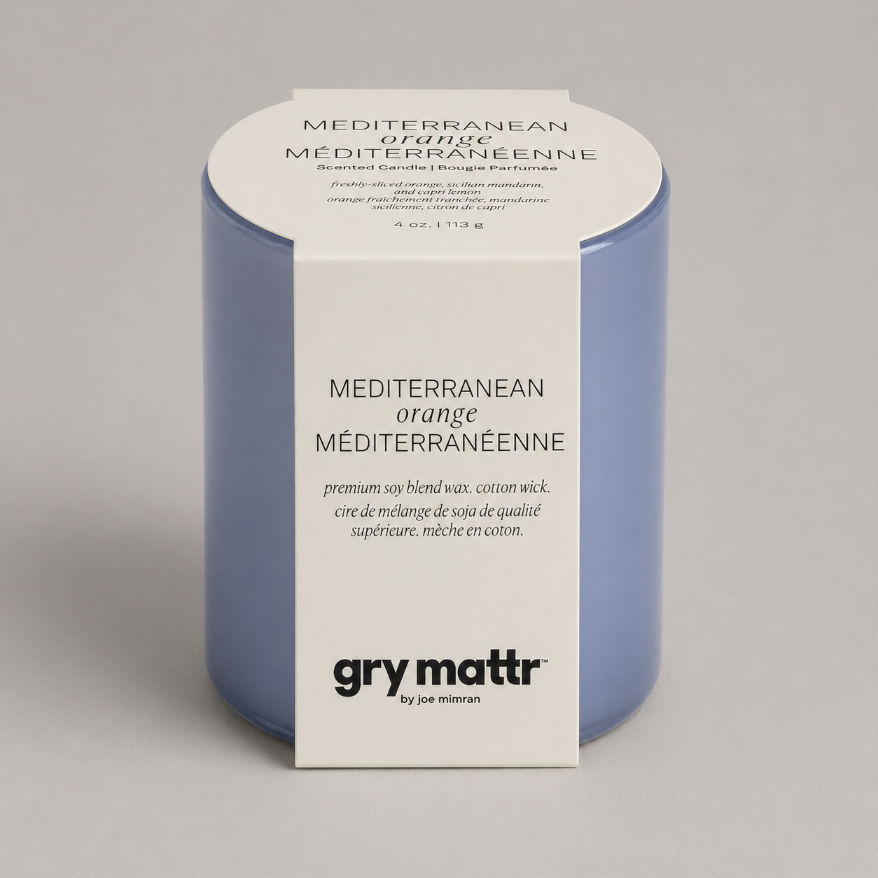 A blue candle in packaging labeled Mediterranean orange, scented candle with description and product details.