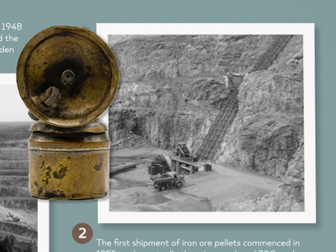 Photograph of a colonial-era mine entrance with rail tracks and mining equipment, and an old rusted megaphone.