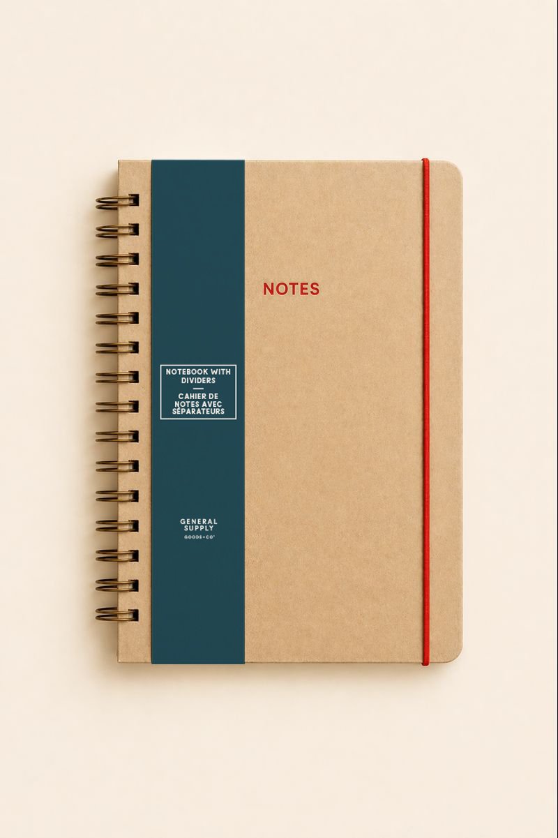 A beige notebook with a dark blue label and a red elastic band, labeled "Notes" on the cover.