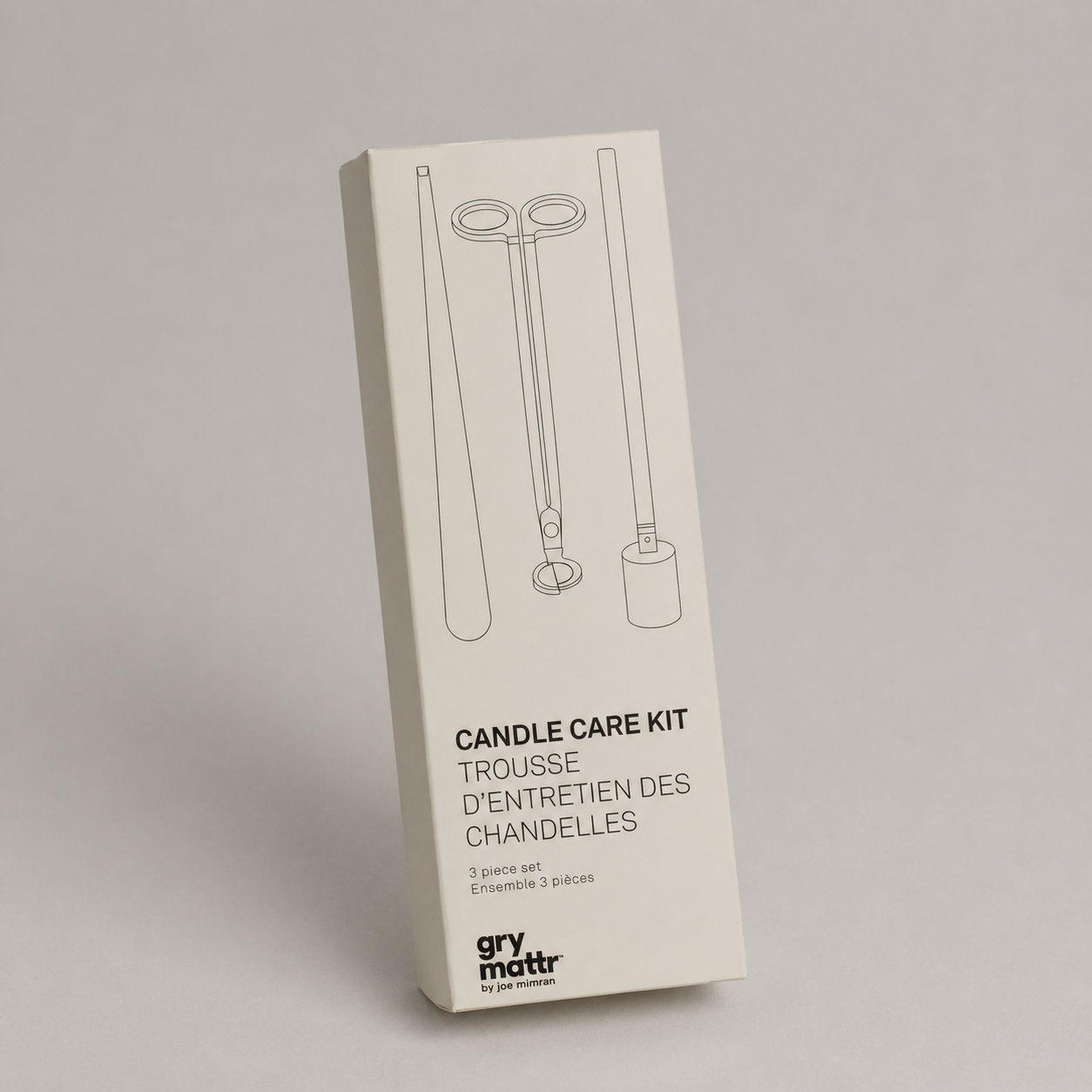 Packaging for a candle care kit by gry mott, including illustrations of candle tools on a white box.