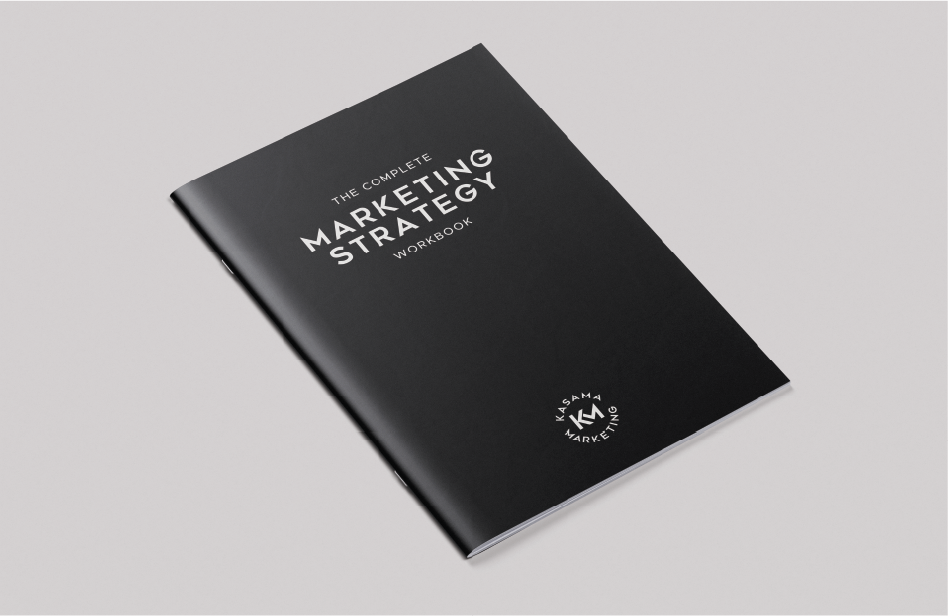 A black workbook titled "The Complete Marketing Strategy Workbook" with white text and a logo at the bottom, placed on a light gray background.
