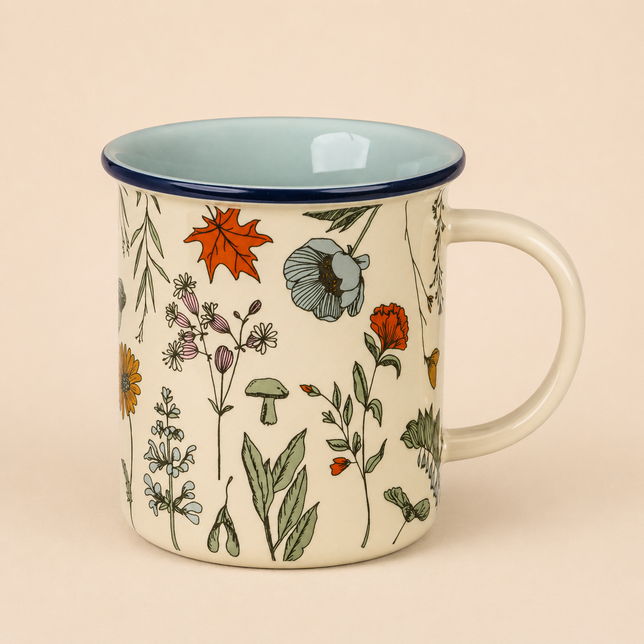 Ceramic mug with a nature-inspired floral and mushroom pattern, cream interior, and a light-colored handle.