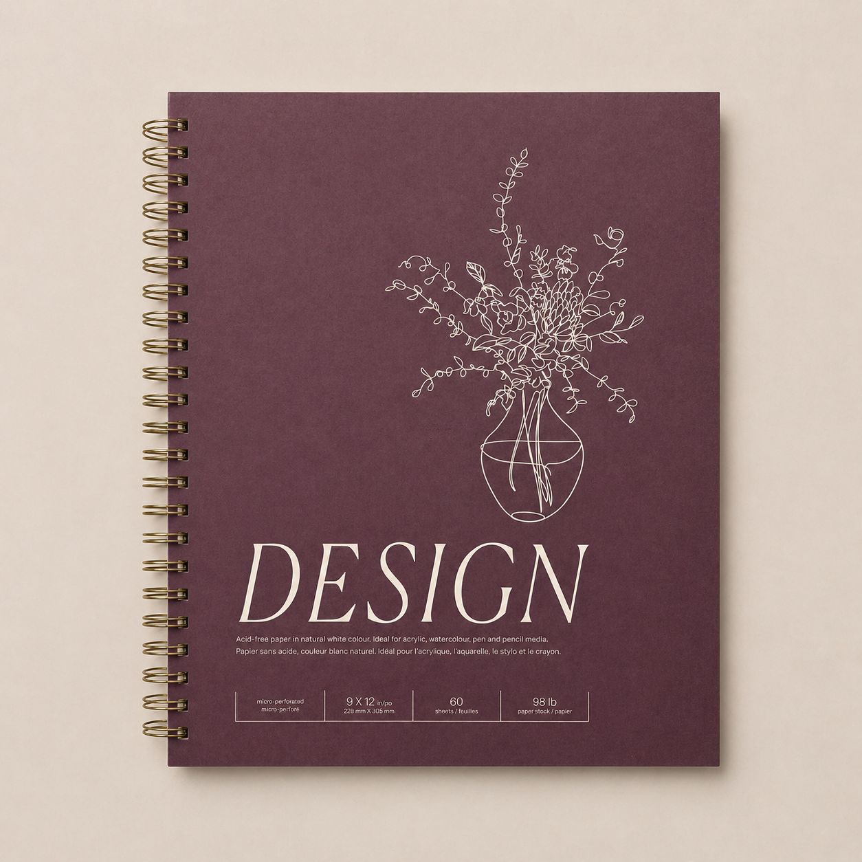 A purple spiral-bound design notebook with a white line drawing of a floral arrangement in a vase on the cover.