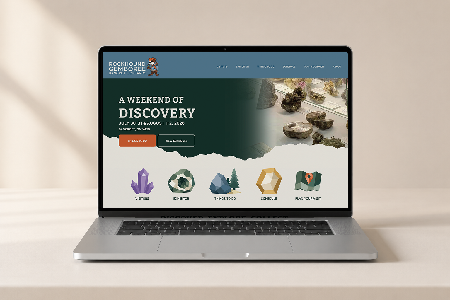 Laptop displaying a website for Rockhound Gemboree in Bancroft, Ontario, featuring event details, navigation menu, and icons for visitors, exhibitor, things to do, schedule, and plan your visit.