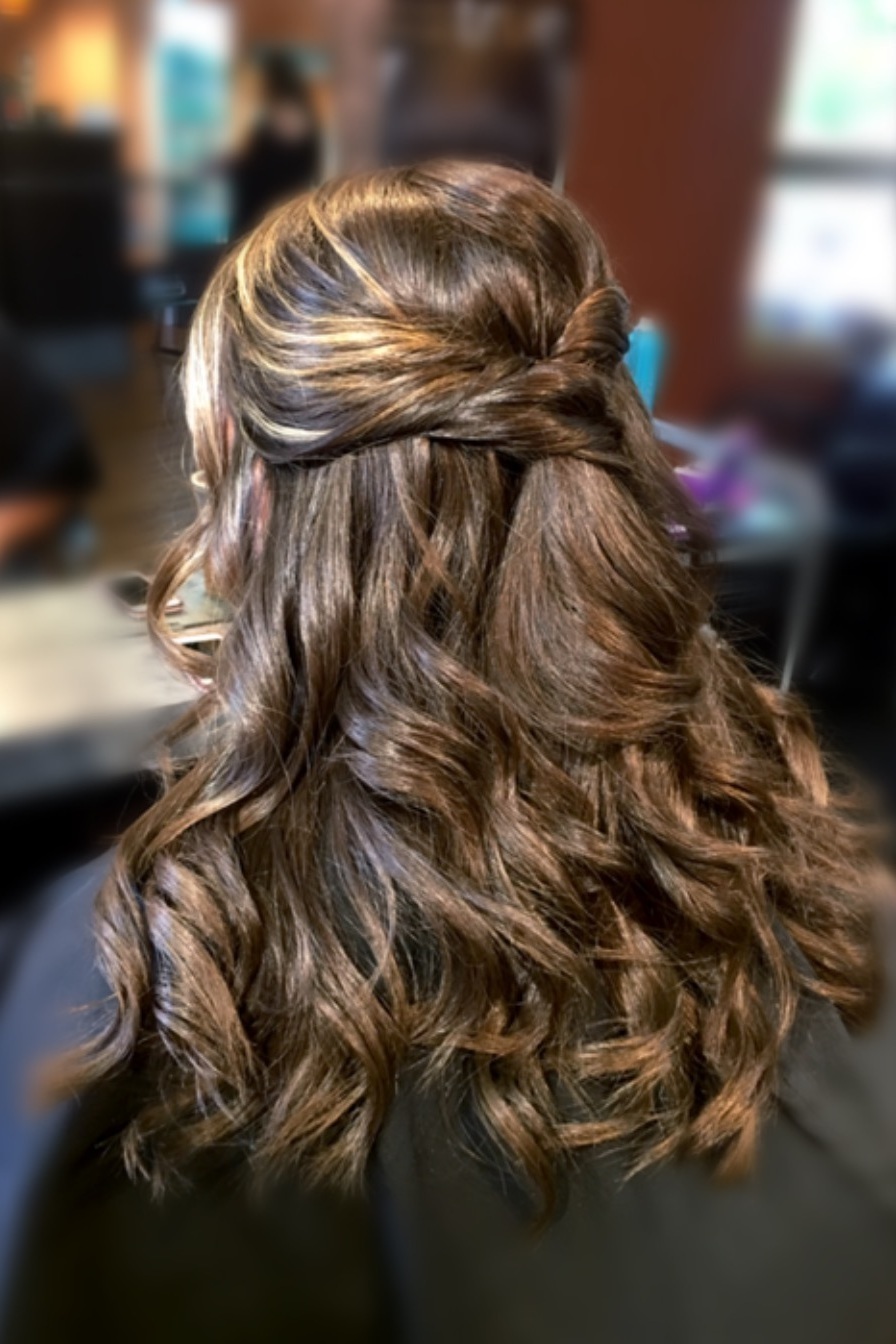 Twisted Half - Up:  This flowy hairstyle has some serious bohemian chic vibes! If you are not a fan of updo’s, consider having your tresses long and curled, with a fun twist to add some flair to this classic silhouette.