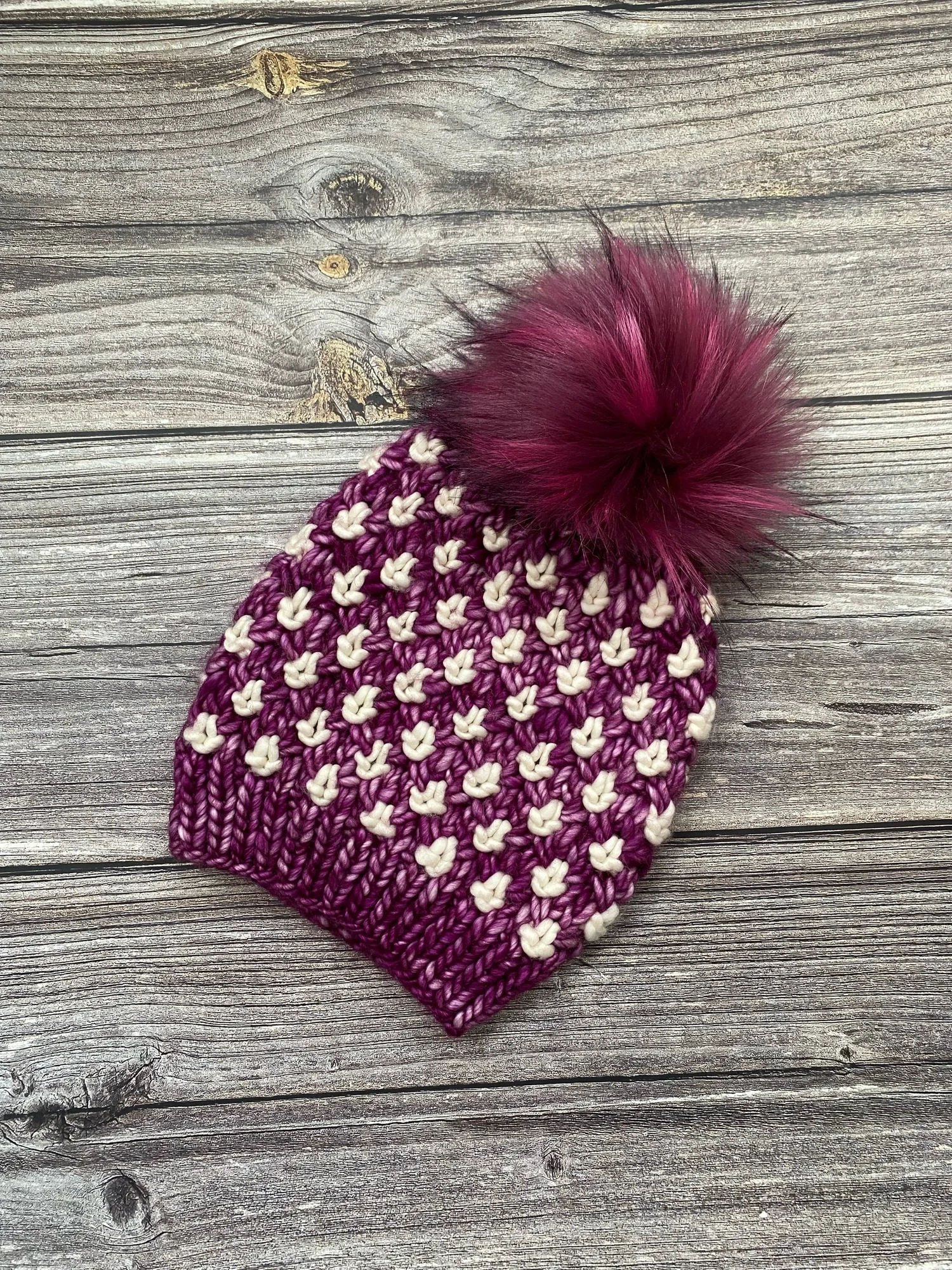 Luxury Handmade Merino Wool Knitted Pom Pom Beanie Hat in Dark Pink and  Ivory — Sophia Dissanayake Design - Main Image