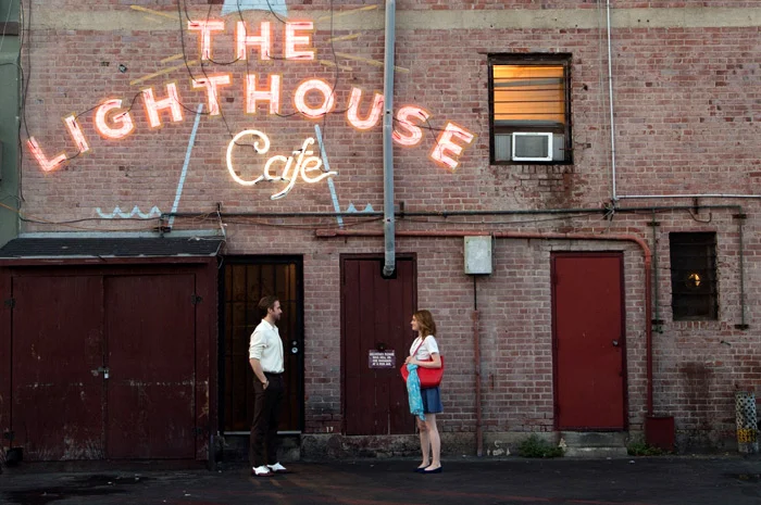 Ryan Gosling and Emma Stone standing outside The Lighthouse Cafe during the movie "La La Land."