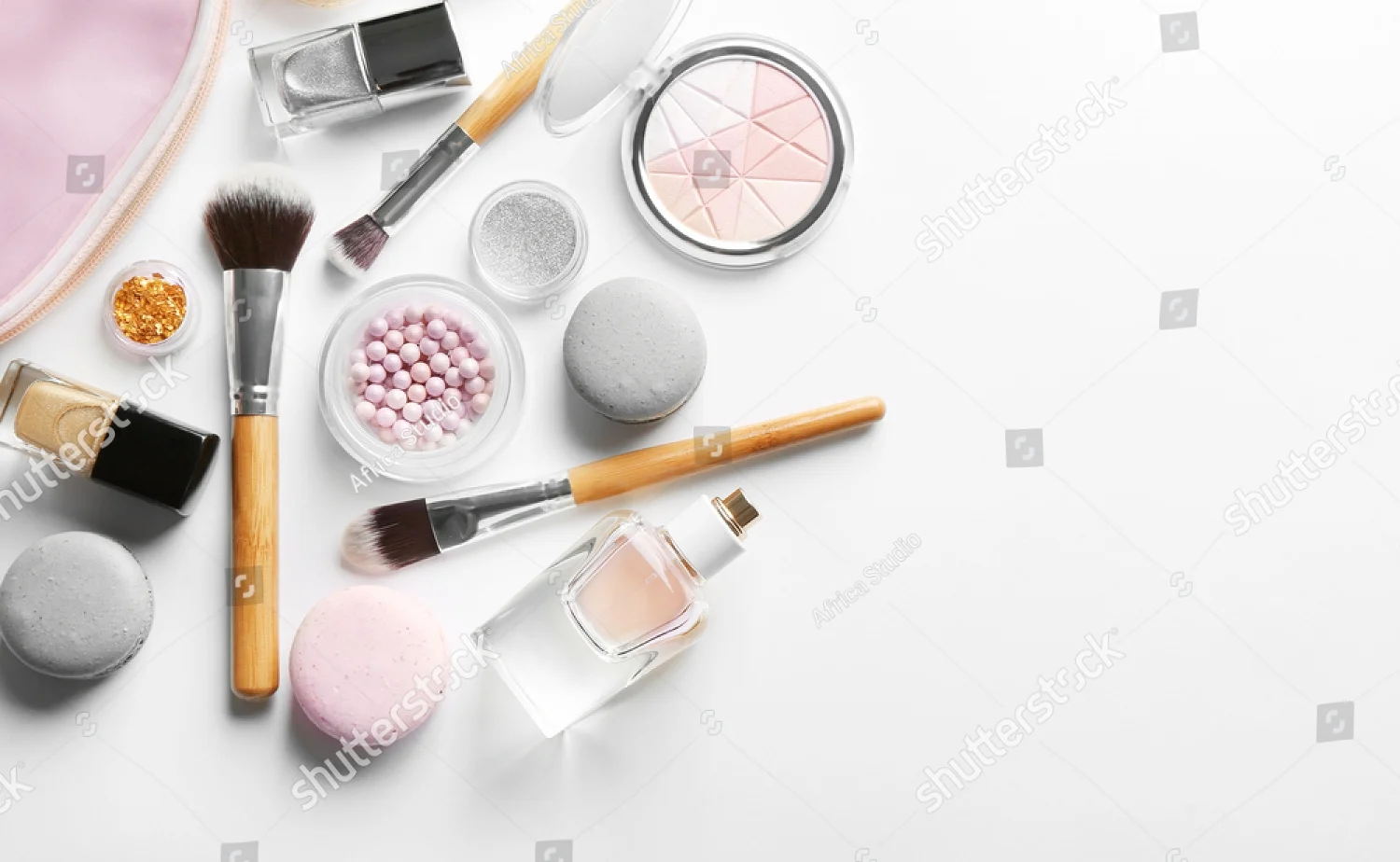 stock-photo-makeup-products-with-cosmetic-bag-and-macaroons-on-light-background-548156077.jpg