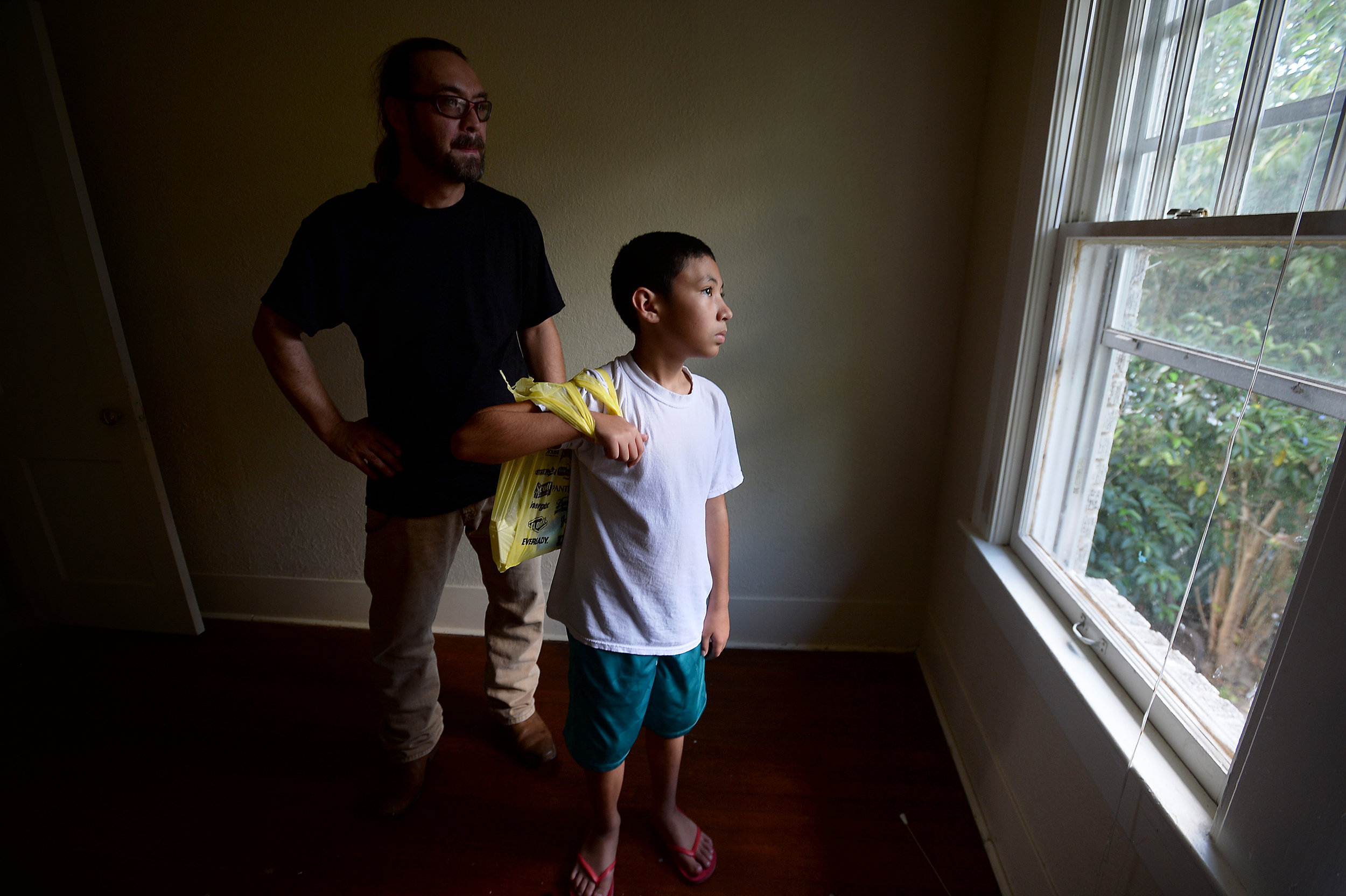 Steven and Steven Kaufman, Jr., stare out the window of an upstairs bedroom as they make a stop at their soon-to-be new home in Old Town. With their FEMA hotel voucher extension due to expire, the Kaufman's were able to find and secure an apartment 
