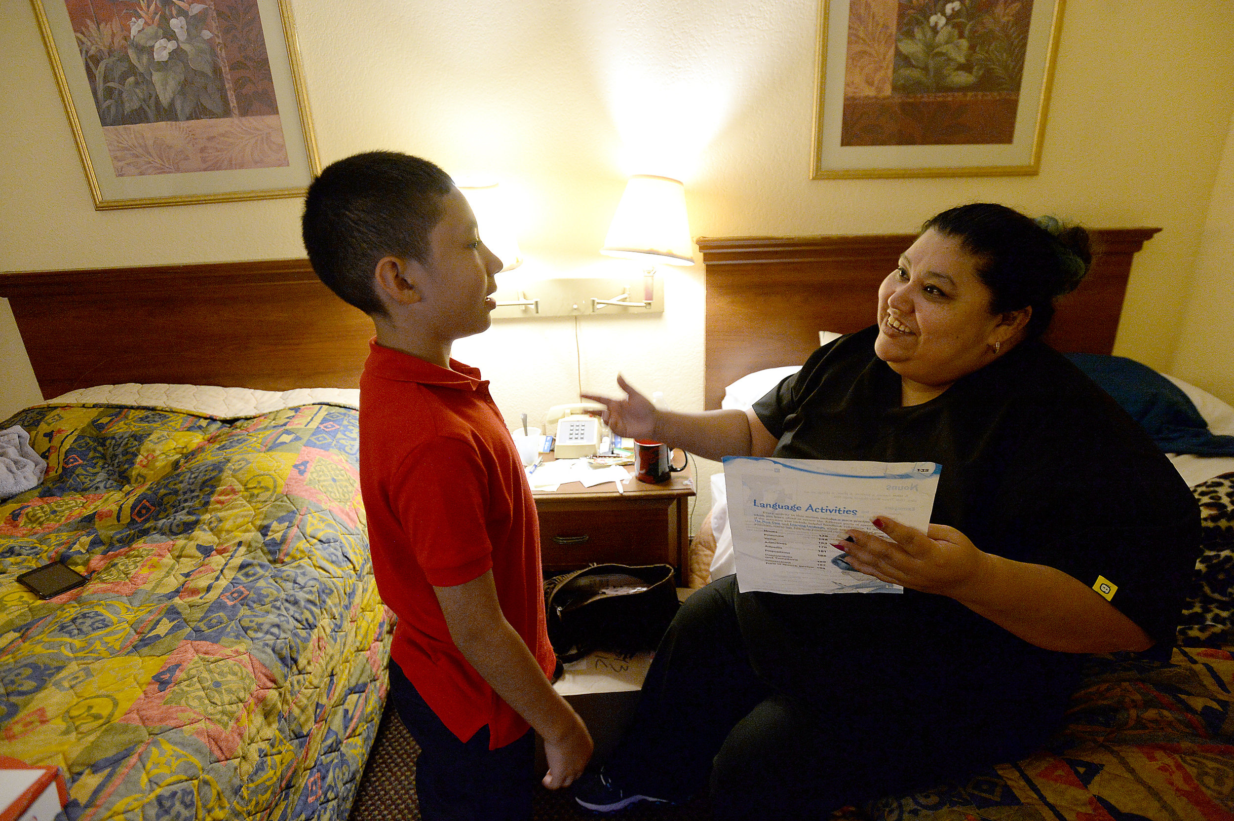  Jennifer Kaufman reviews son Stevie's completed homework in their hotel room in the Beaumont Lodge. The family have been staying there on a FEMA voucher after evacuating their flooded home 3 weeks ago.
Photo taken Wednesday, September 27, 2017
Kim B